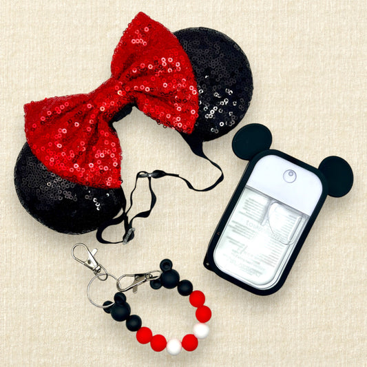 Black sequin mouse ears with red sequin bow on an elastic headband; spray hand sanitizer in black mouse ears case; red and black beaded mouse ears holder clip