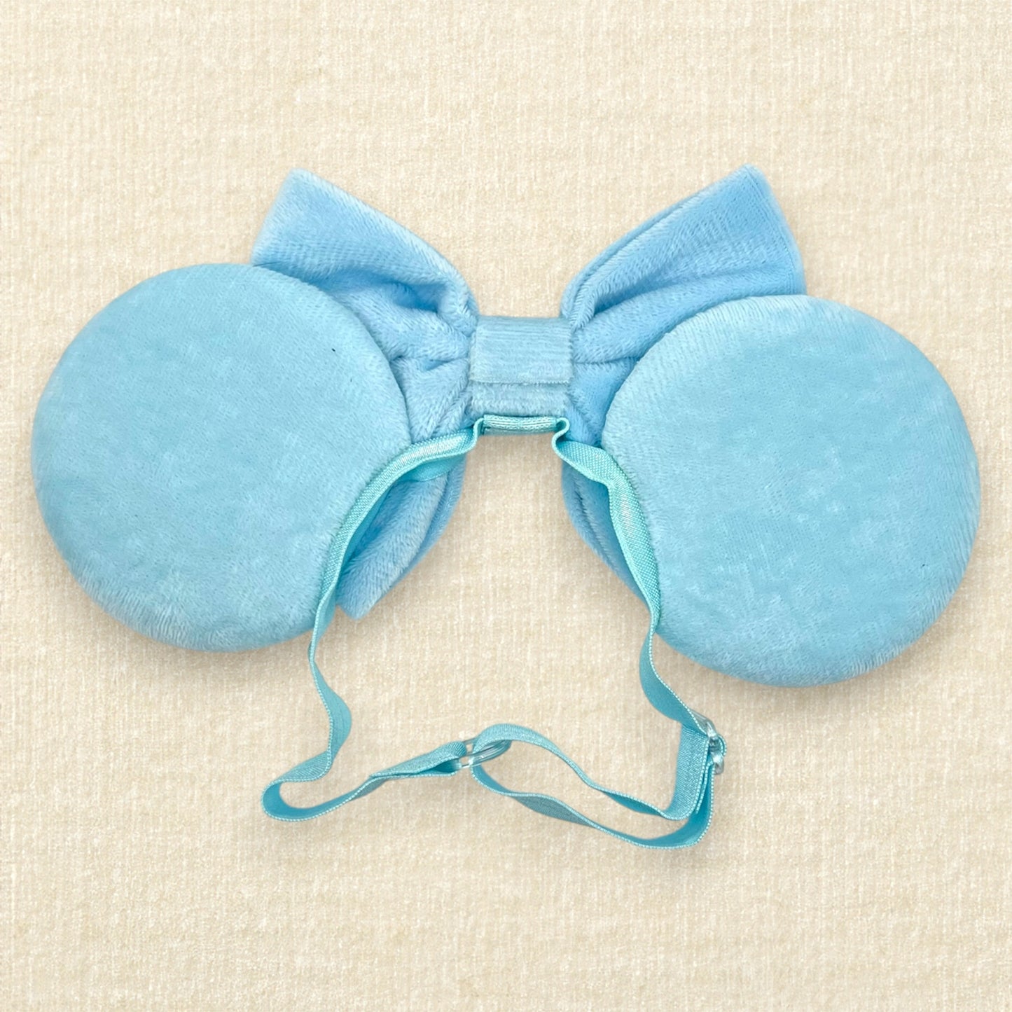 Blue velvet mouse ears and bow with pink fabric flowers on an elastic headband (back view)
