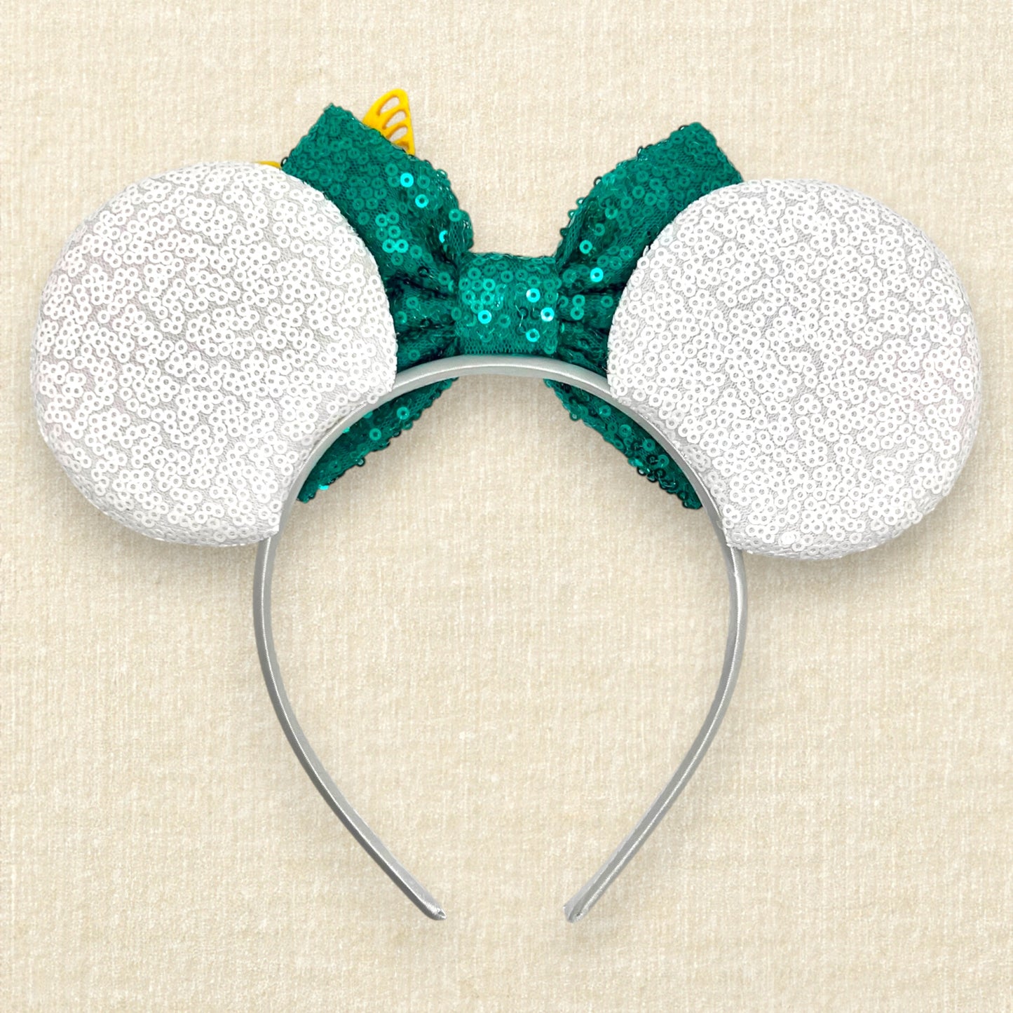 White sequin mouse ears with butterflies and flower details and a green sequin bow (back view)