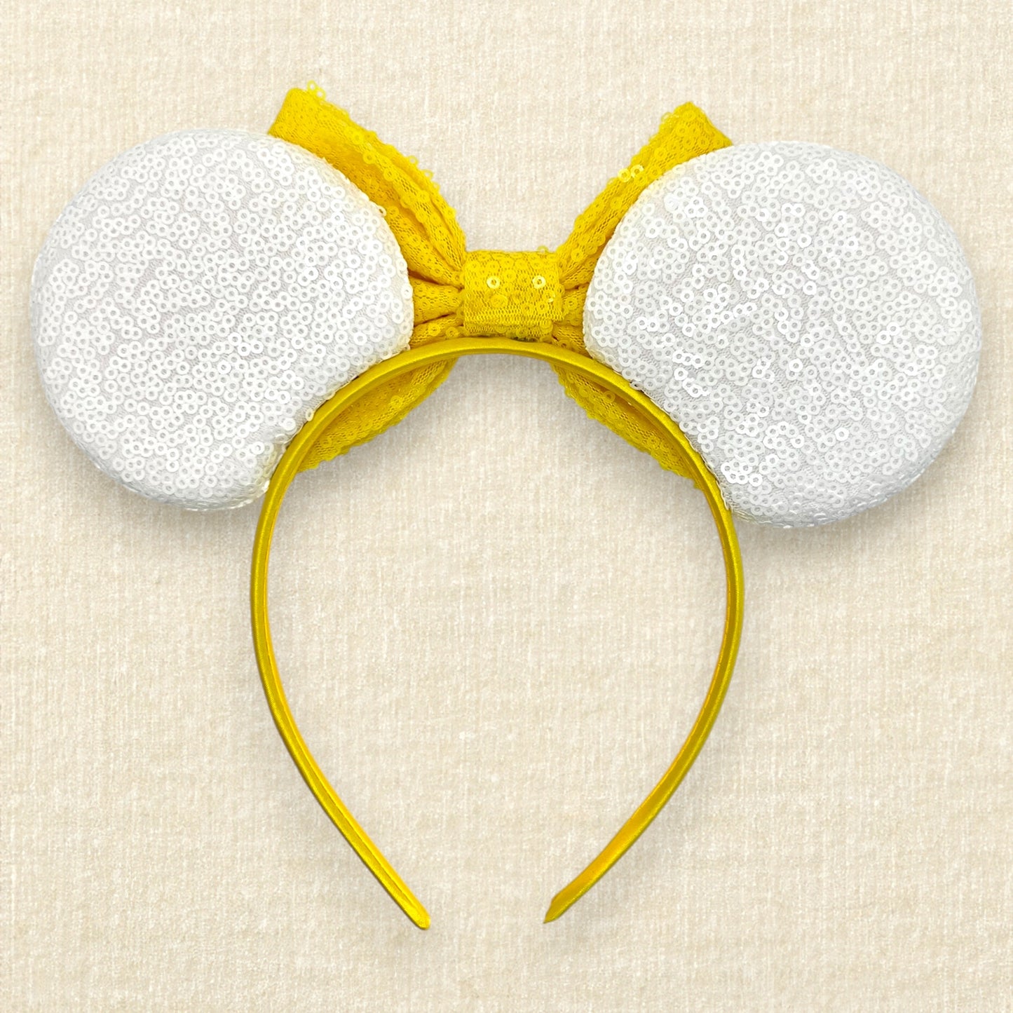 Halloween-themed mouse ears headband with white ears, candy corn pieces, rhinestones, and a yellow bow (back view)