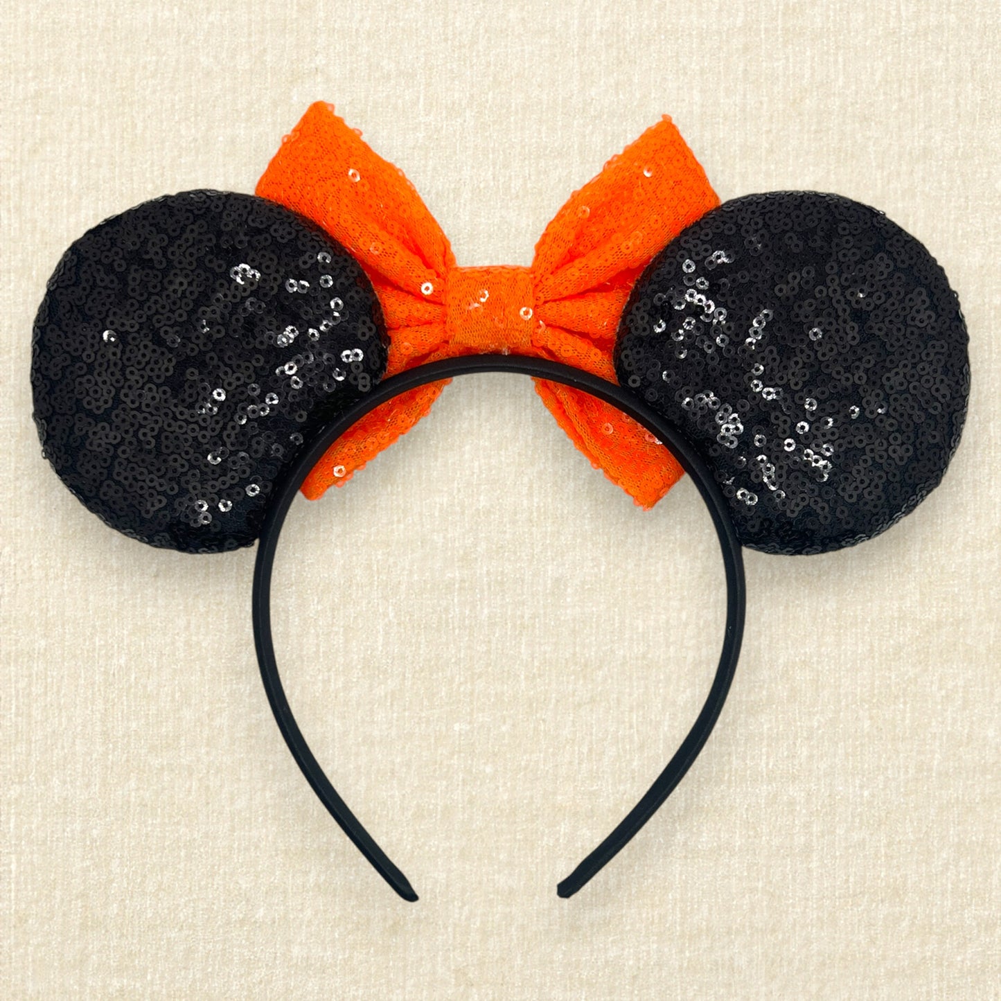 Black sequin Halloween-themed mouse ears with candy corn pieces, rhinestones, and orange sequin bow (back view)