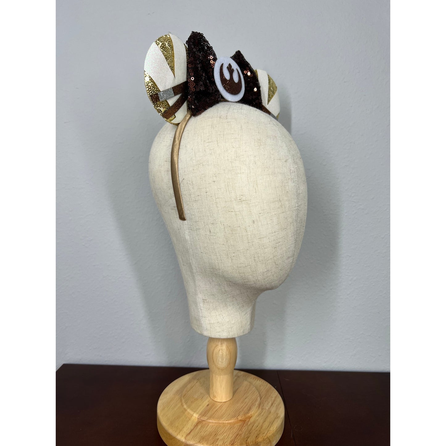 Decorative headband on a mannequin head with a plain background