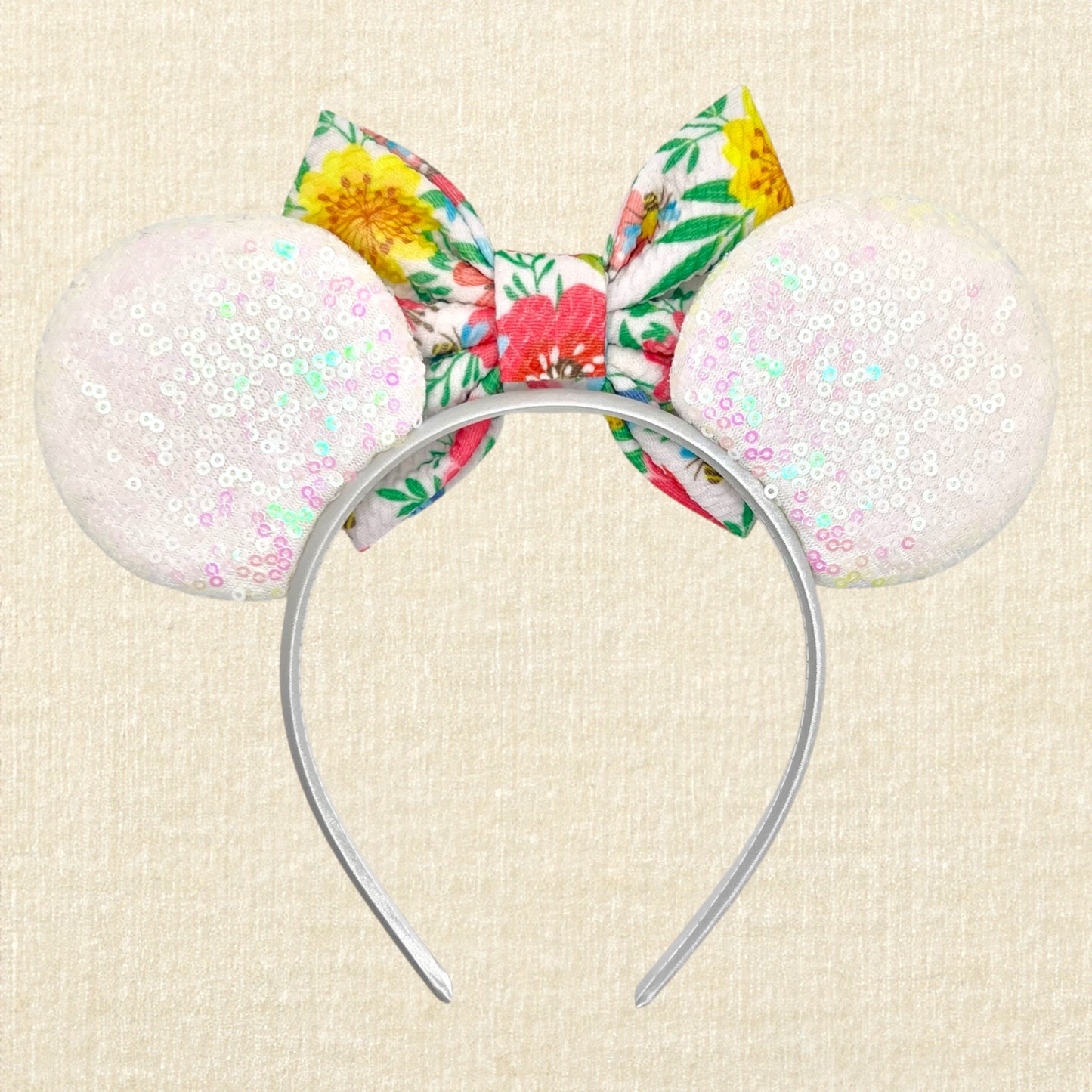 Iridescent white mouse ears headband with colorful floral fabric bow (back view)