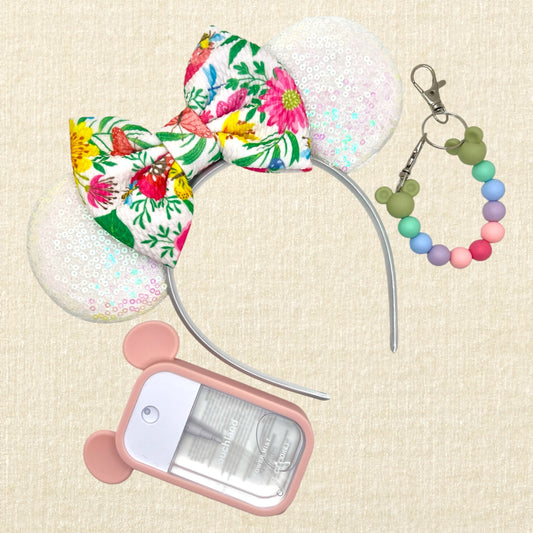 Iridescent white mouse ears headband with colorful floral fabric bow; spray hand sanitizer in a pink mouse case; colorful beaded mouse ears holder keychain