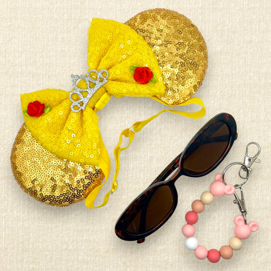 Gold sequin mouse ears with a yellow bow, silver tiara, and red roses on an elastic headband; sunglasses; pink beaded mouse ears holder keychain