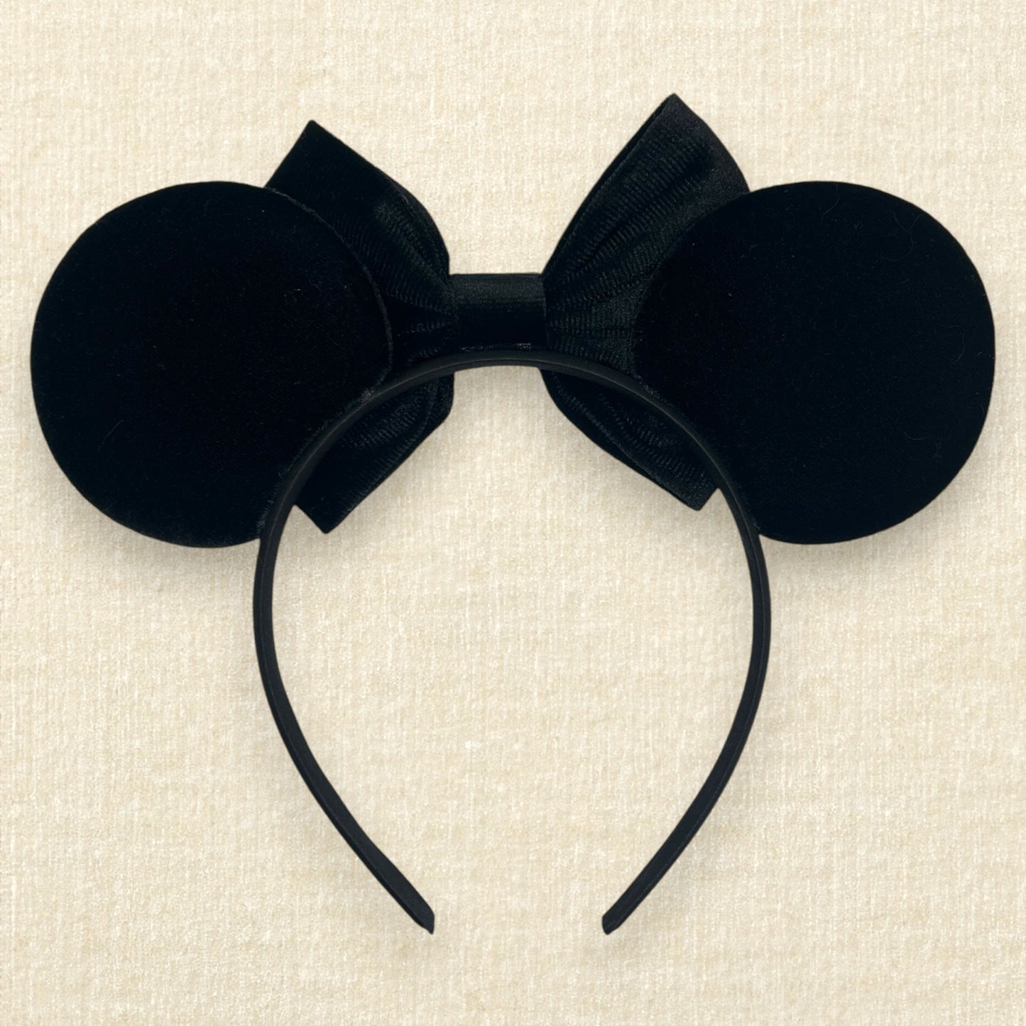 Black velvet mouse ears with black velvet bow and colorful rhinestones in a red, orange, yellow, and crystal ombre gradient pattern (back view)