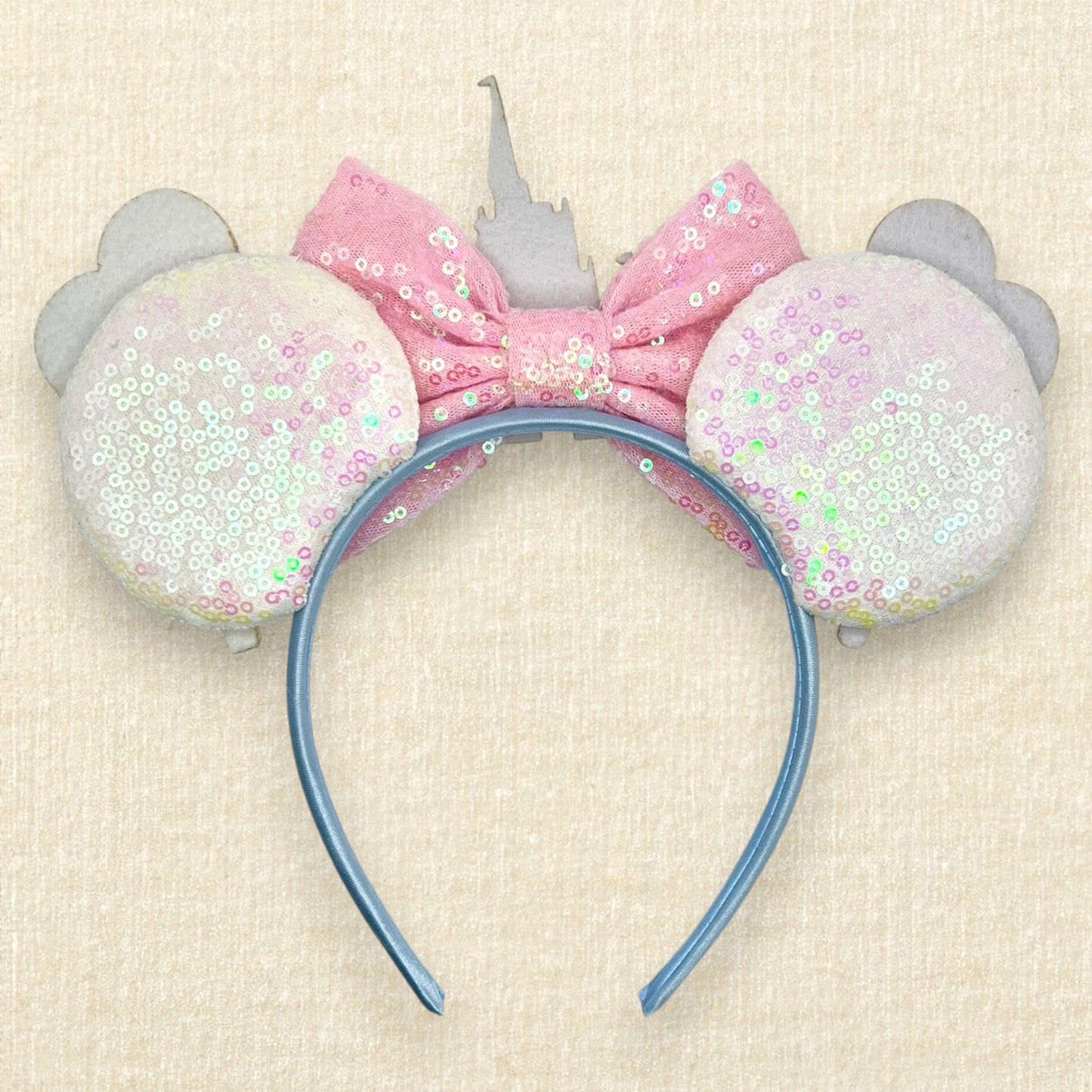White sequin mouse ears with colorful mouse balloons and a pink bow with pastel pink and blue castle centerpiece (back view)