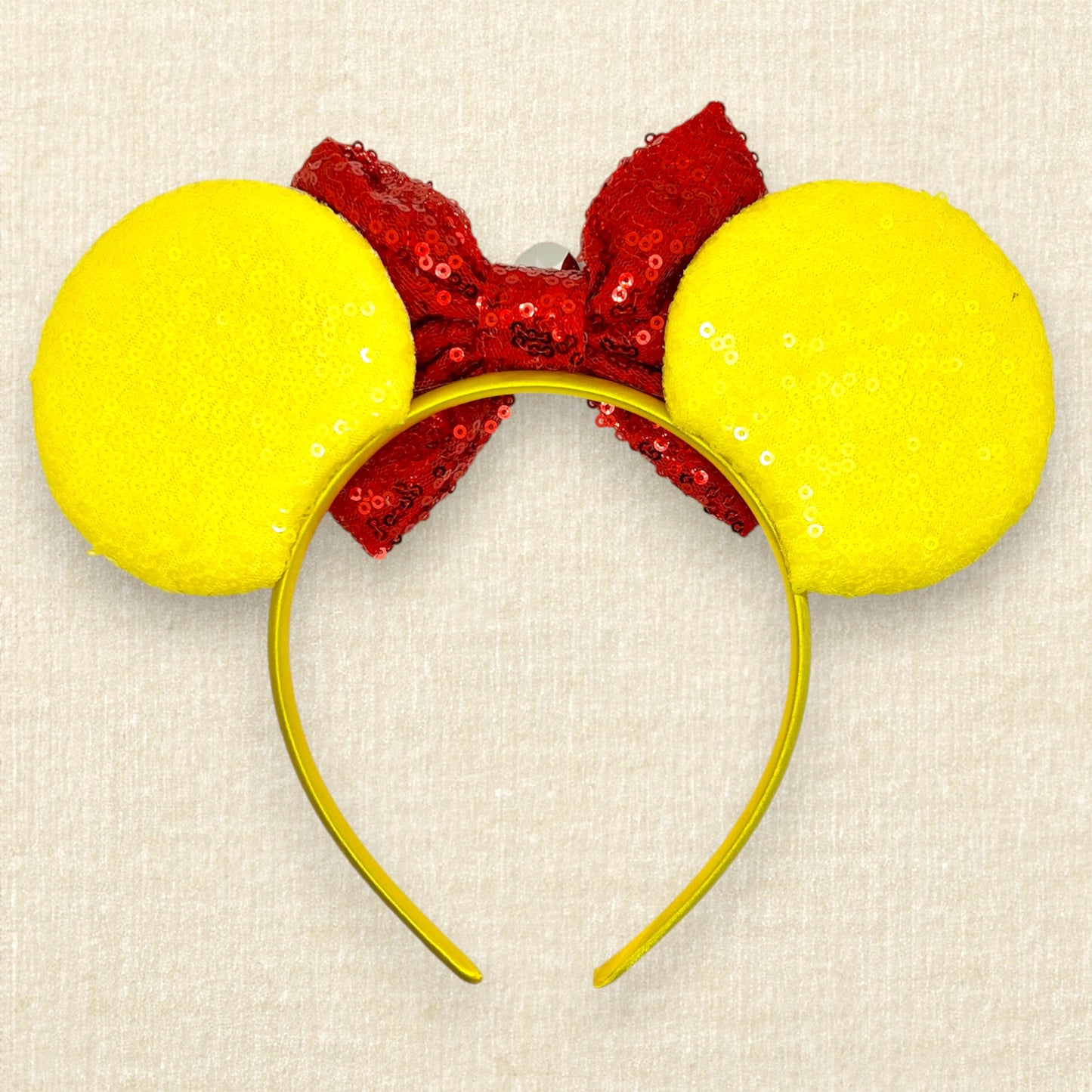 Yellow sequin mouse ears with gold glitter honey and black bumblebee accents, and red sequin bow with wooden honey dipper and gold rhinestone (back view)