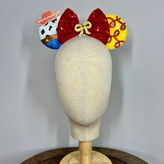 Colorful sequin mouse ears headband with cowboy details on a mannequin head against a gray background
