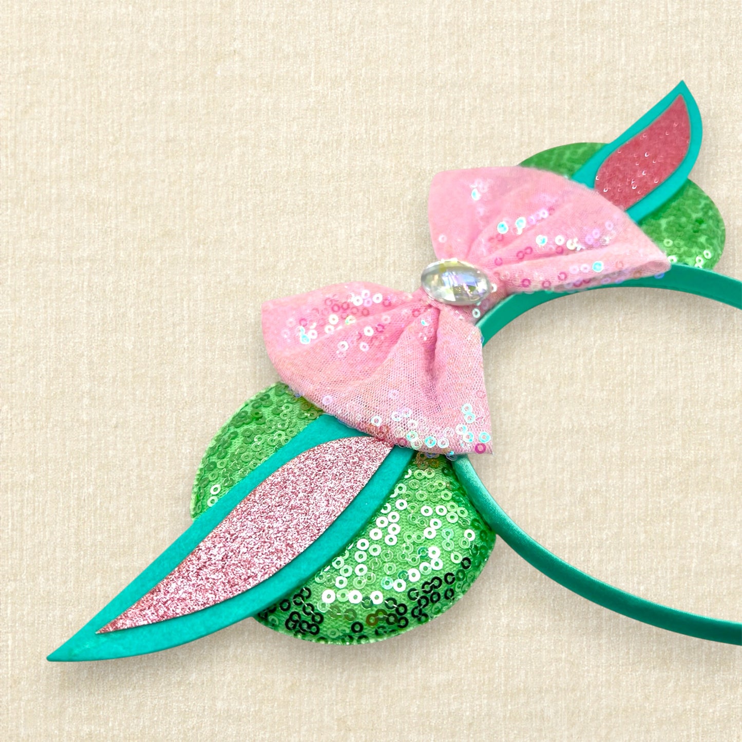 Light green sequin mouse ears headband with pink sequin bow and green and pink alien ears