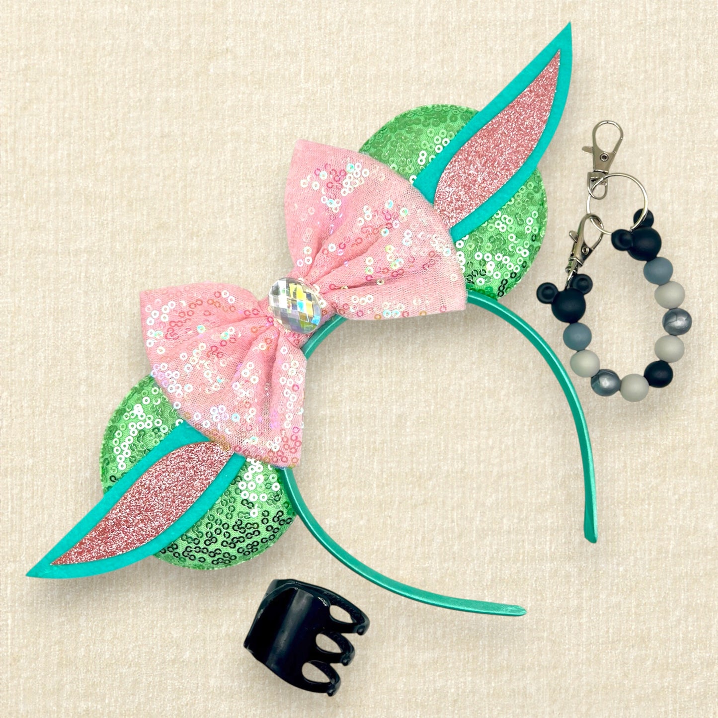 Light green sequin mouse ears headband with pink sequin bow and green and pink alien ears; black claw clip; black and gray beaded mouse ears holder clip
