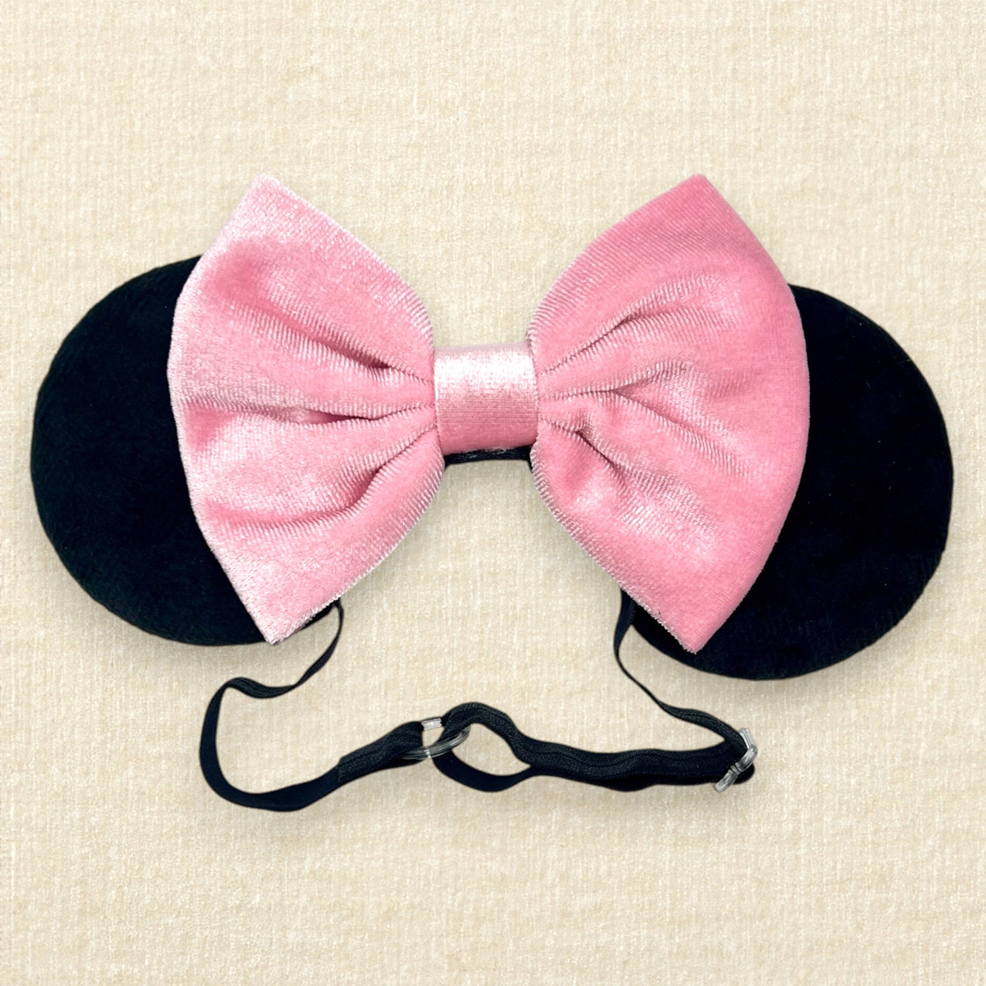 Black velvet mouse ears with pink velvet bow on an elastic headband