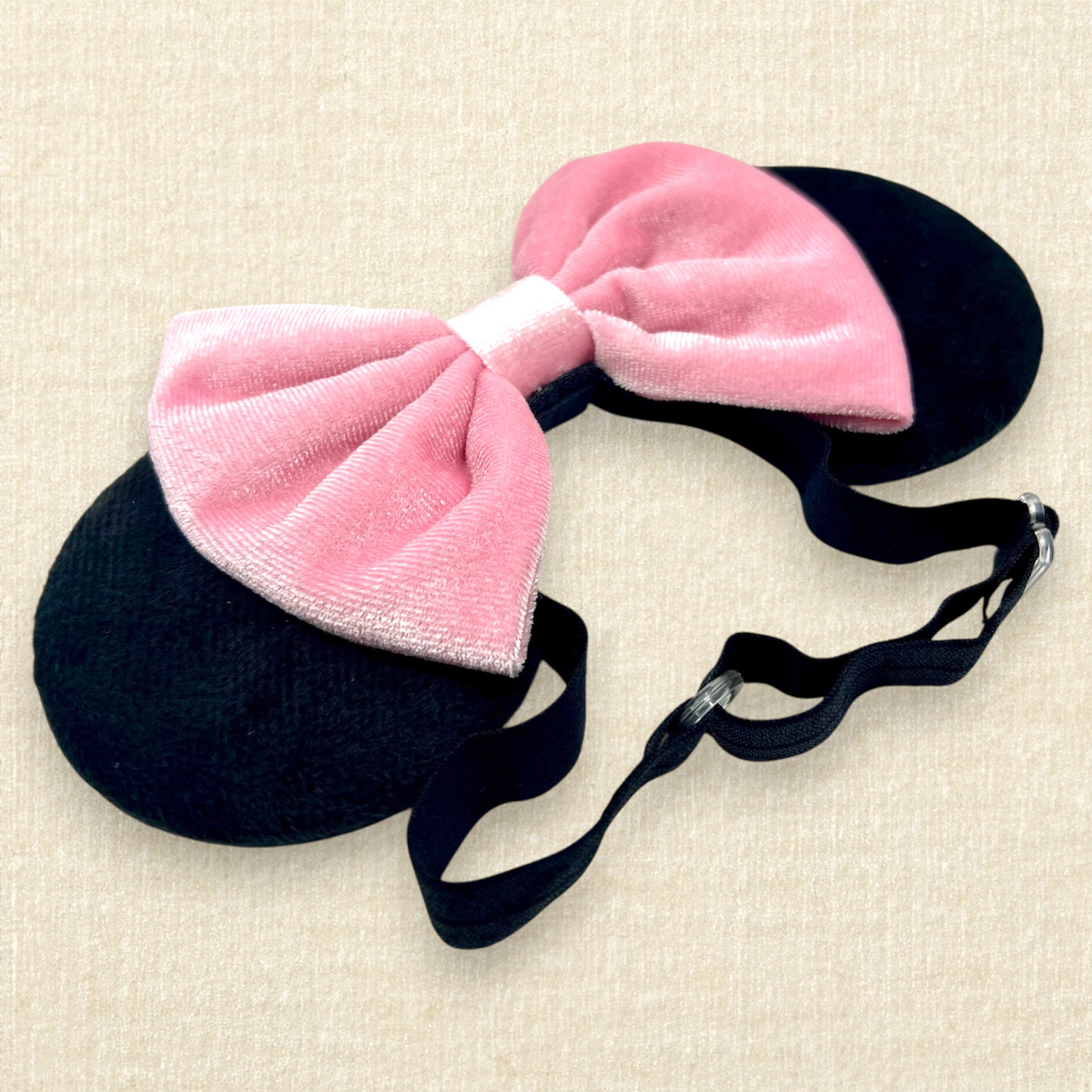 Black velvet mouse ears with pink velvet bow on an elastic headband