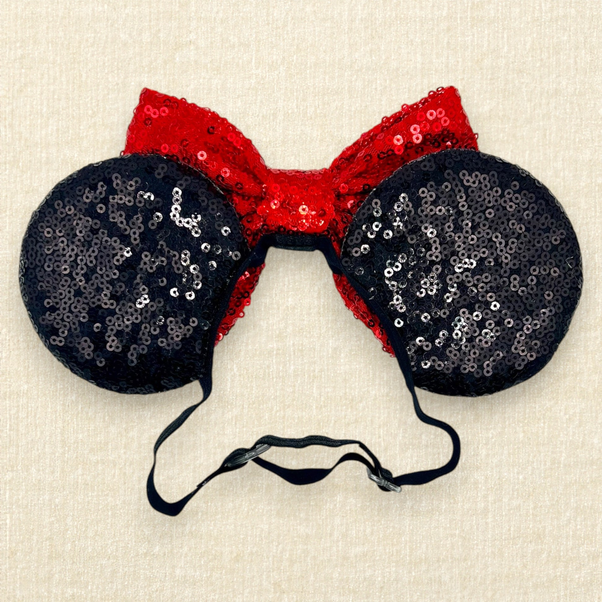 Black sequin mouse ears with red sequin bow on an elastic headband (back view)