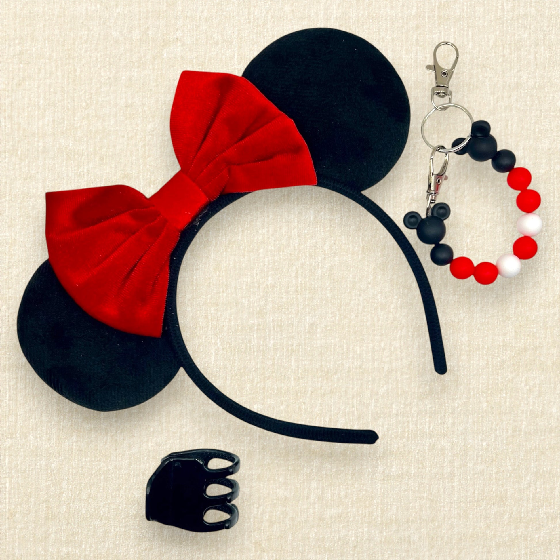 Black velvet mouse ears headband with red velvet bow; black claw clip; black, white, and red beaded mouse ears holder