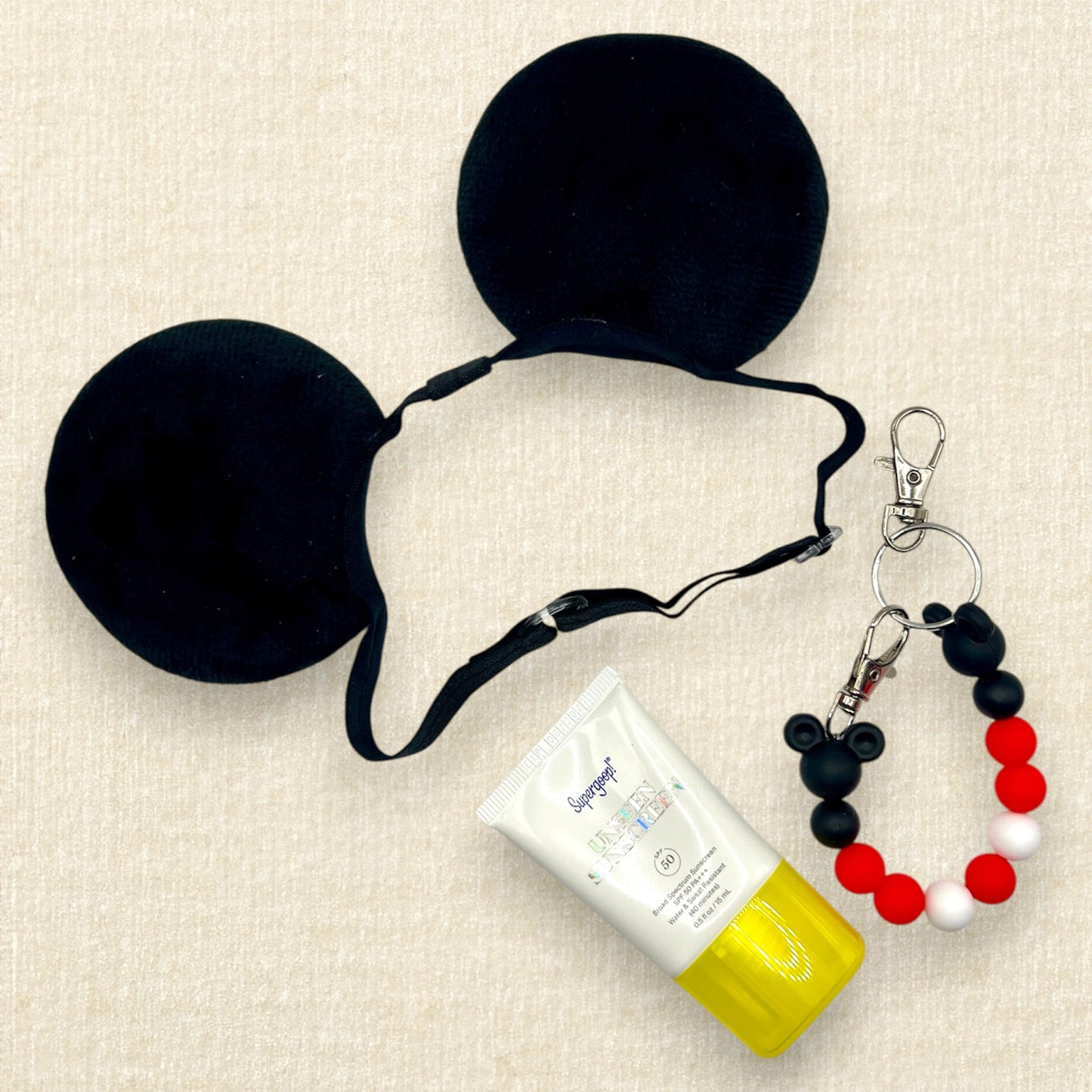 Black velvet bow-free mouse ears on an elastic headband; sunscreen; black, red, and white beaded mouse ears holder clip