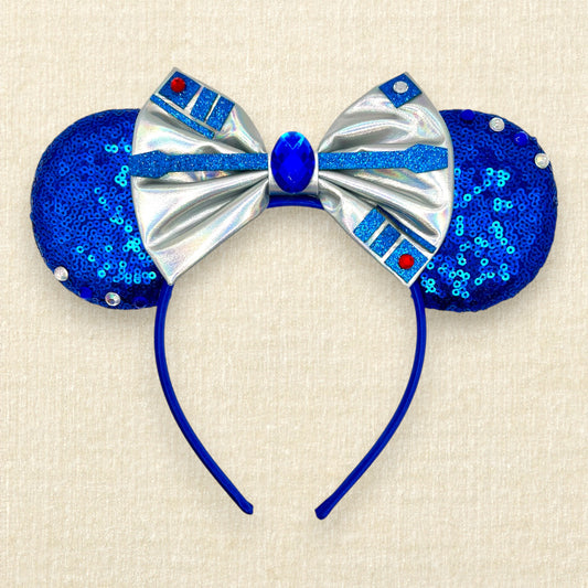 Blue mouse ears with metallic silver bow, rhinestones, and glitter robot-inspired details
