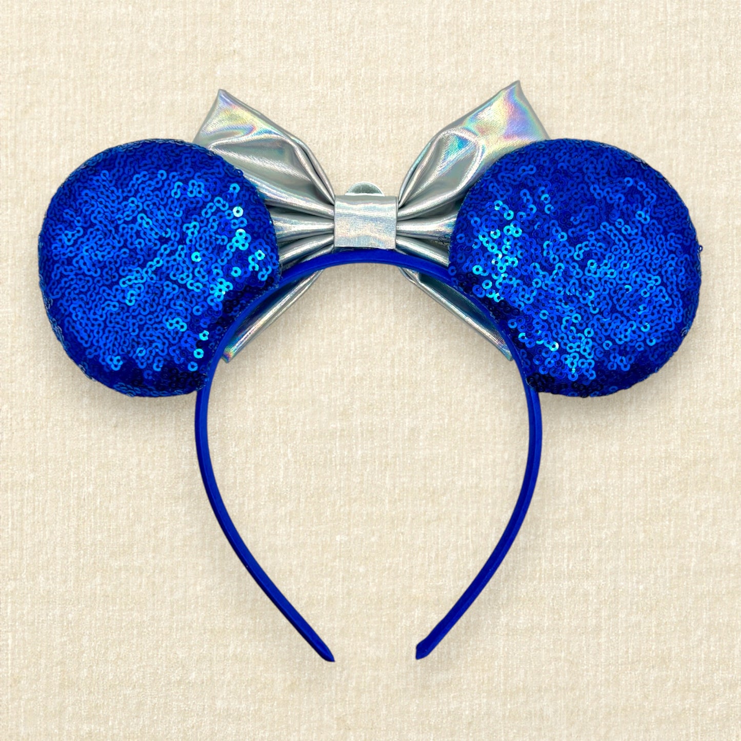 Blue mouse ears with metallic silver bow, rhinestones, and glitter robot-inspired details