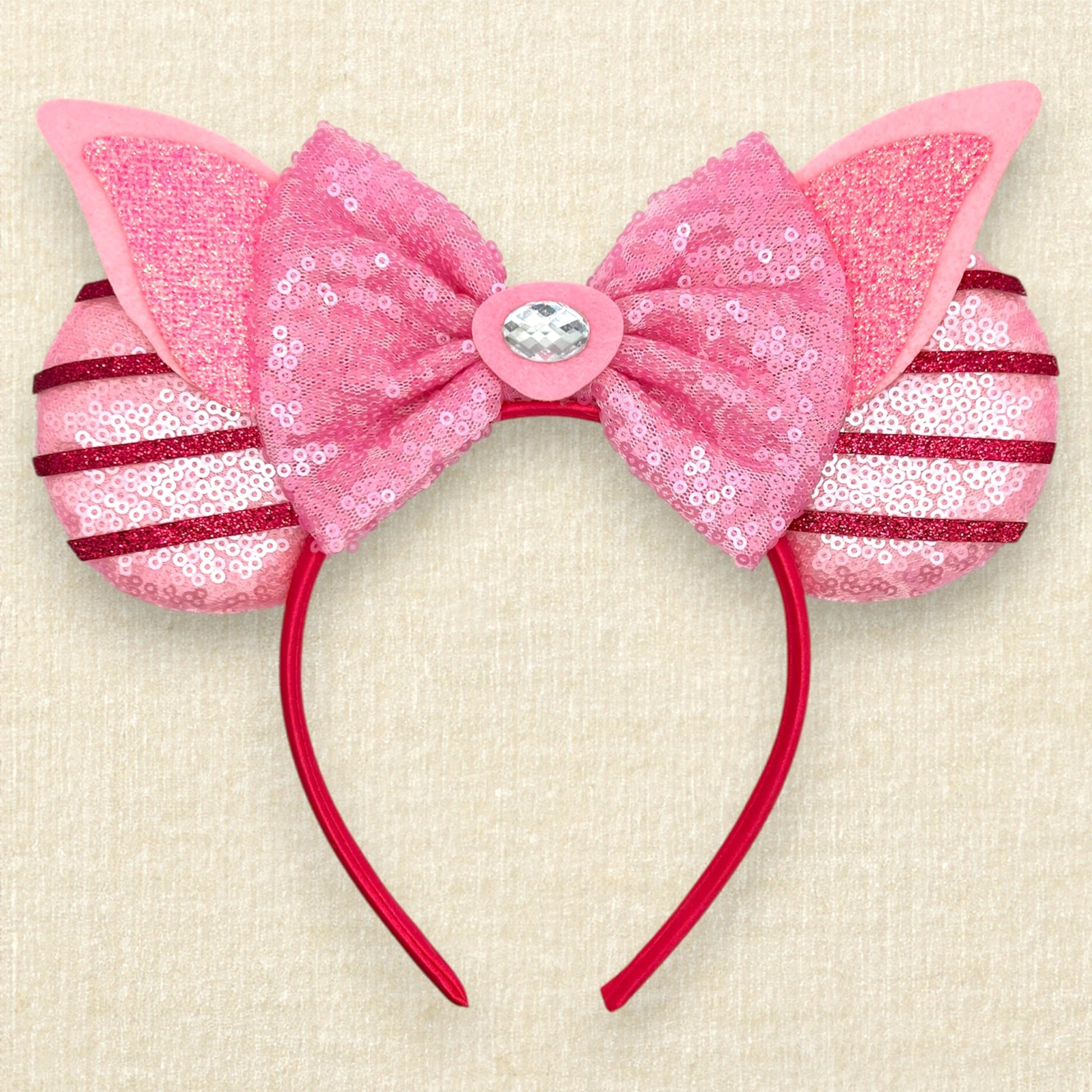 Pink sequin mouse ears with dark pink glitter stripes, pink sequin bow, pink glitter piglet ears, and rhinestone pig nose