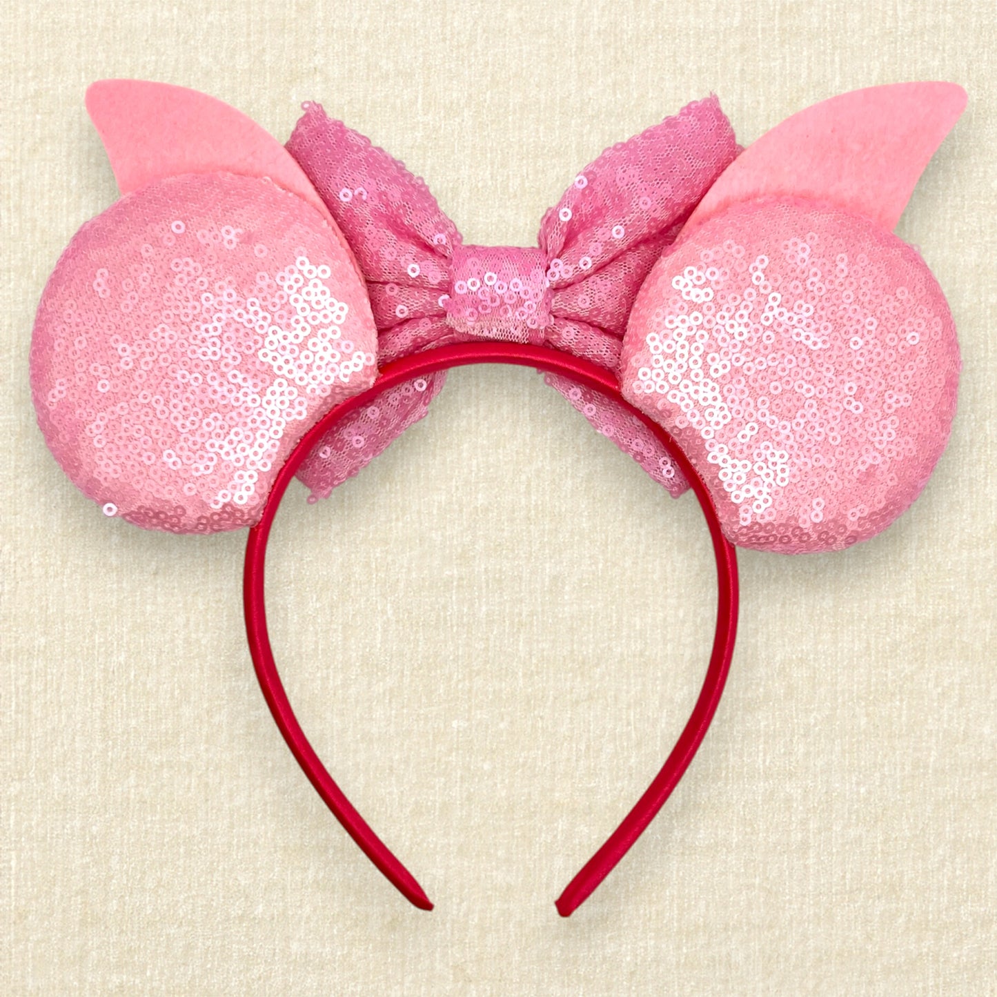 Pink sequin mouse ears with dark pink glitter stripes, pink sequin bow, pink glitter piglet ears, and rhinestone pig nose (back view)