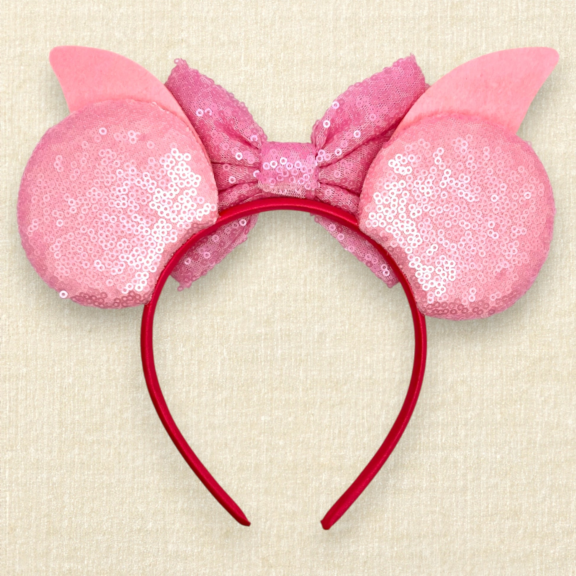 Pink sequin mouse ears with dark pink glitter stripes, pink sequin bow, pink glitter piglet ears, and rhinestone pig nose (back view)
