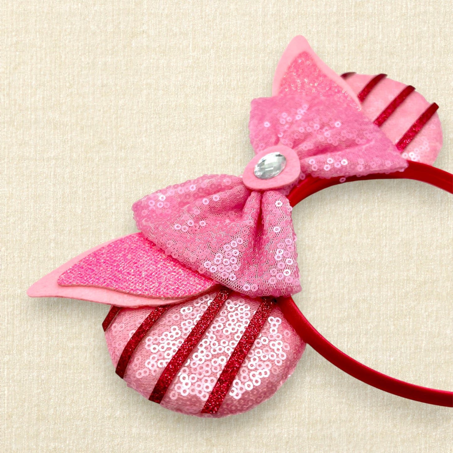 Pink sequin mouse ears with dark pink glitter stripes, pink sequin bow, pink glitter piglet ears, and rhinestone pig nose
