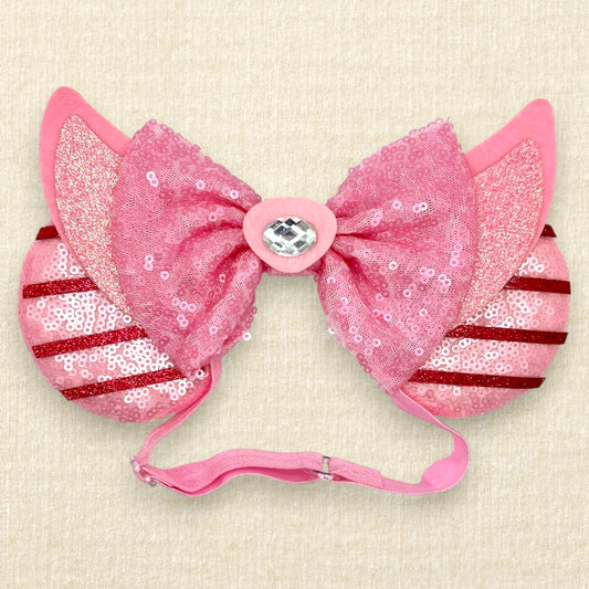 Pink sequin mouse ears with dark pink glitter stripes, pink sequin bow, and glitter piglet ears and nose detail on an elastic headband