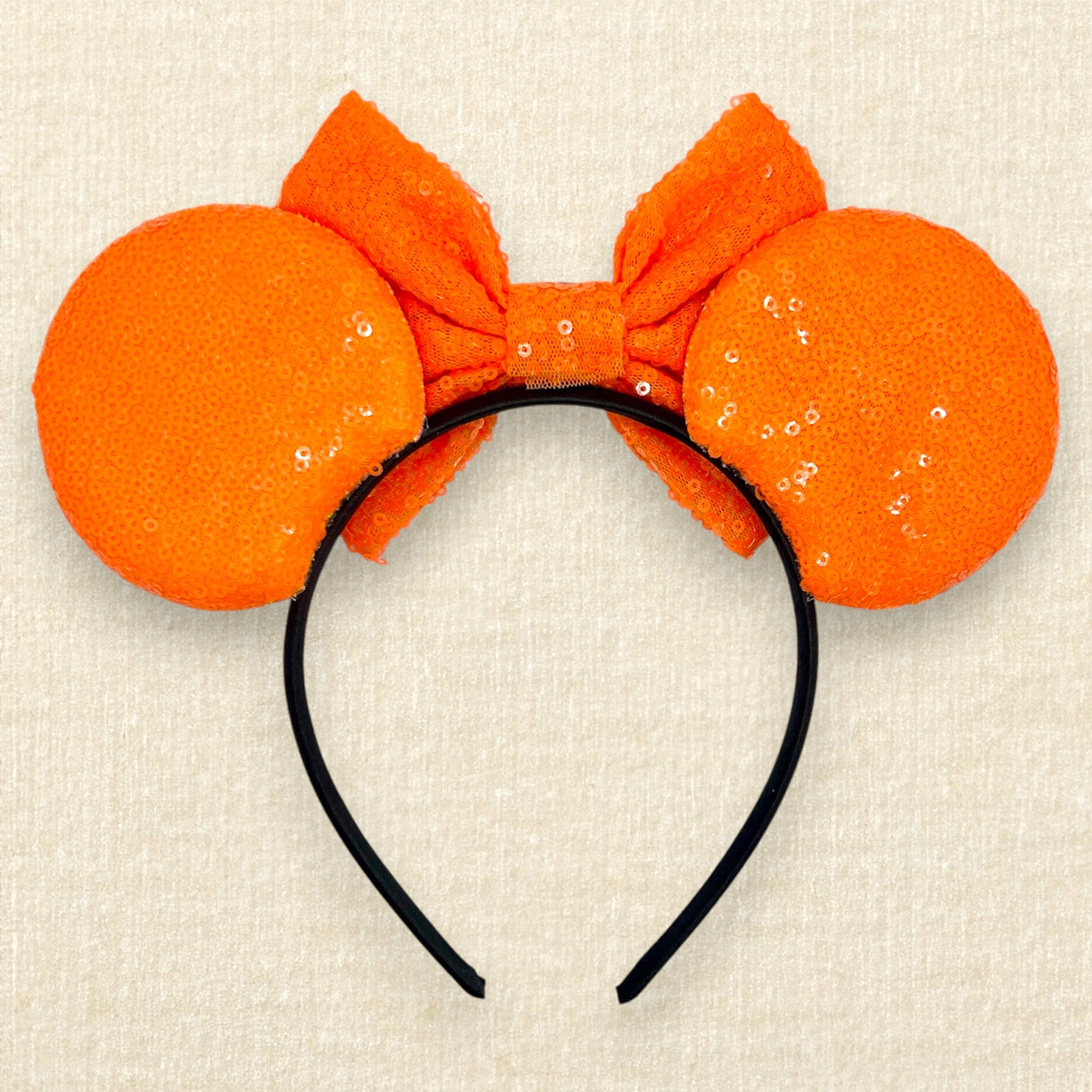 Orange sequin mouse ears headband with matching bow, black glitter tiger stripes, and rhinestone nose with black glitter whiskers (back view)