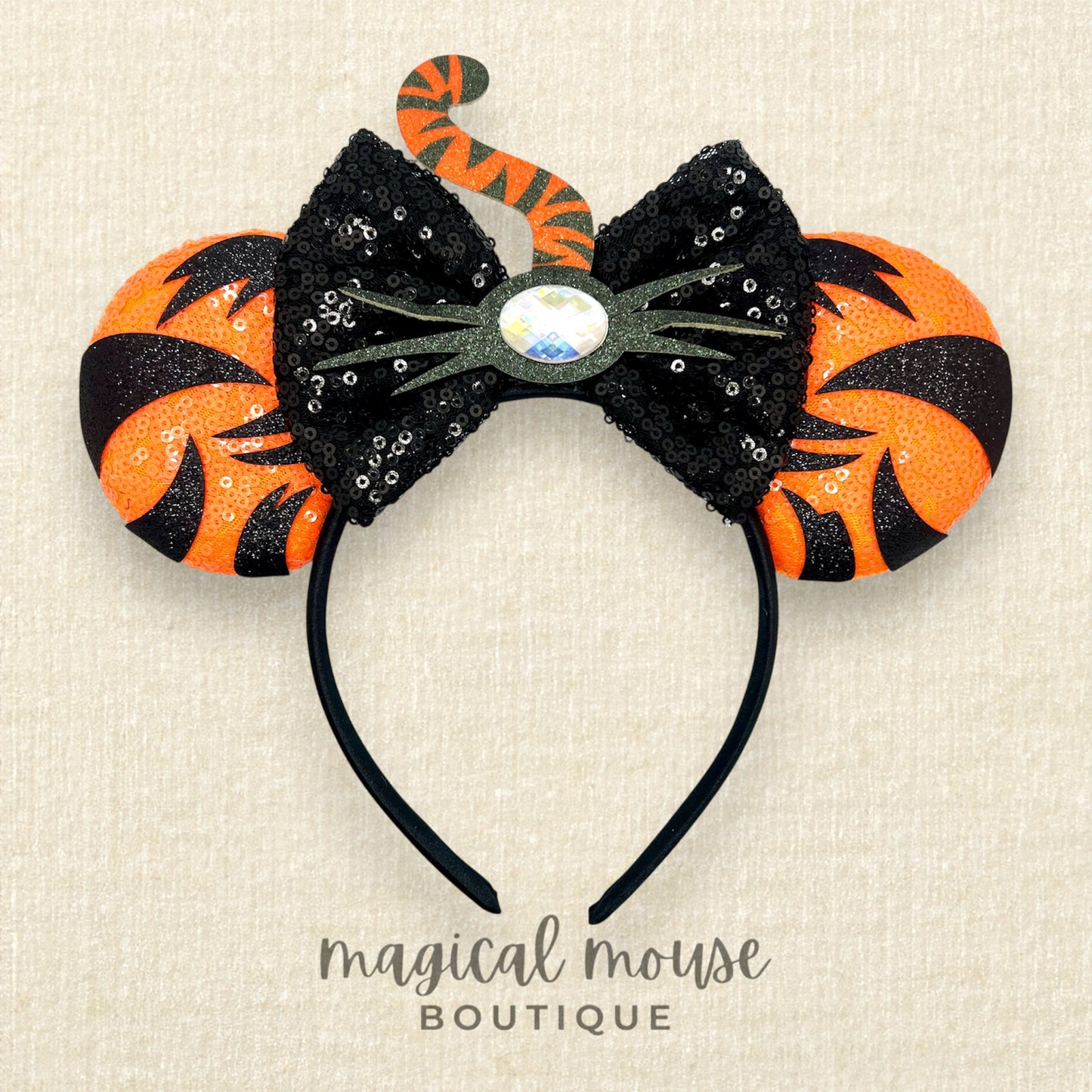 Orange mouse ears with black sequin bow, with black tiger stripes, black glitter whiskers, rhinestone nose, and orange and black tiger tail centerpiece