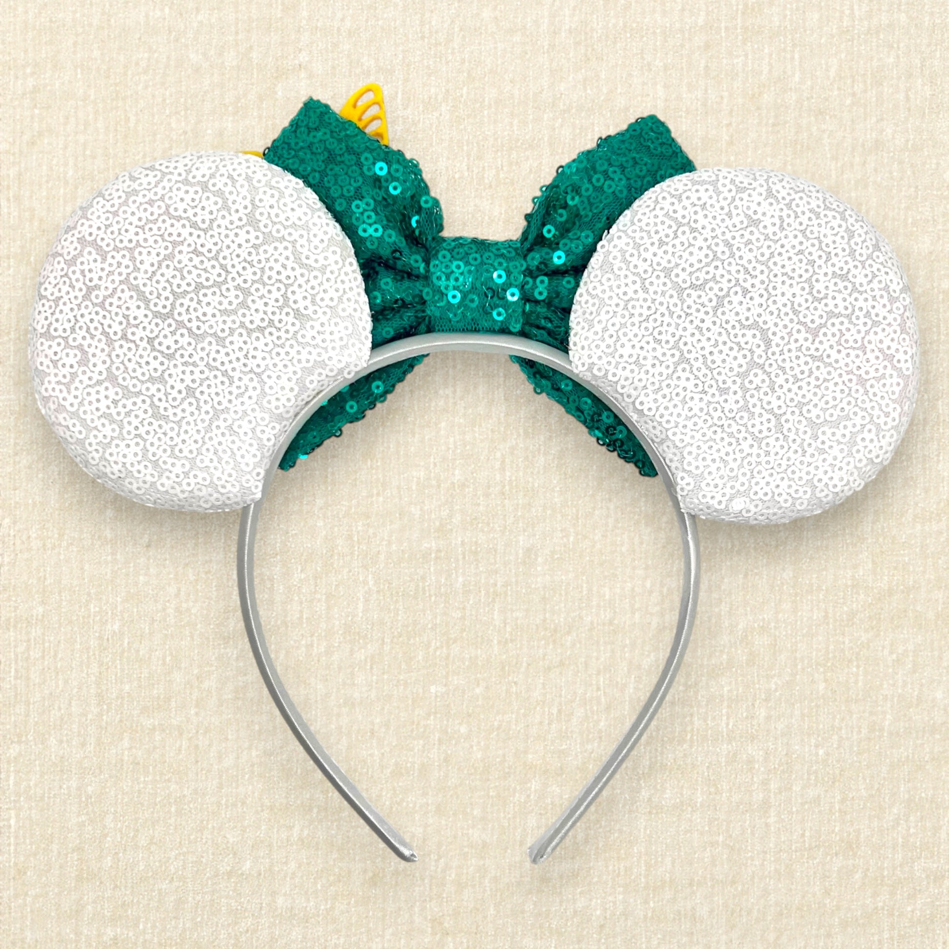 White sequin mouse ears with butterflies and flower details and a green sequin bow (back view)