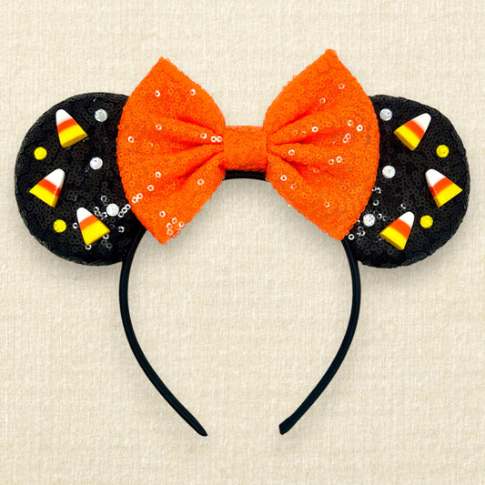 Black sequin mouse ears with candy corn pieces, rhinestones, and orange sequin bow