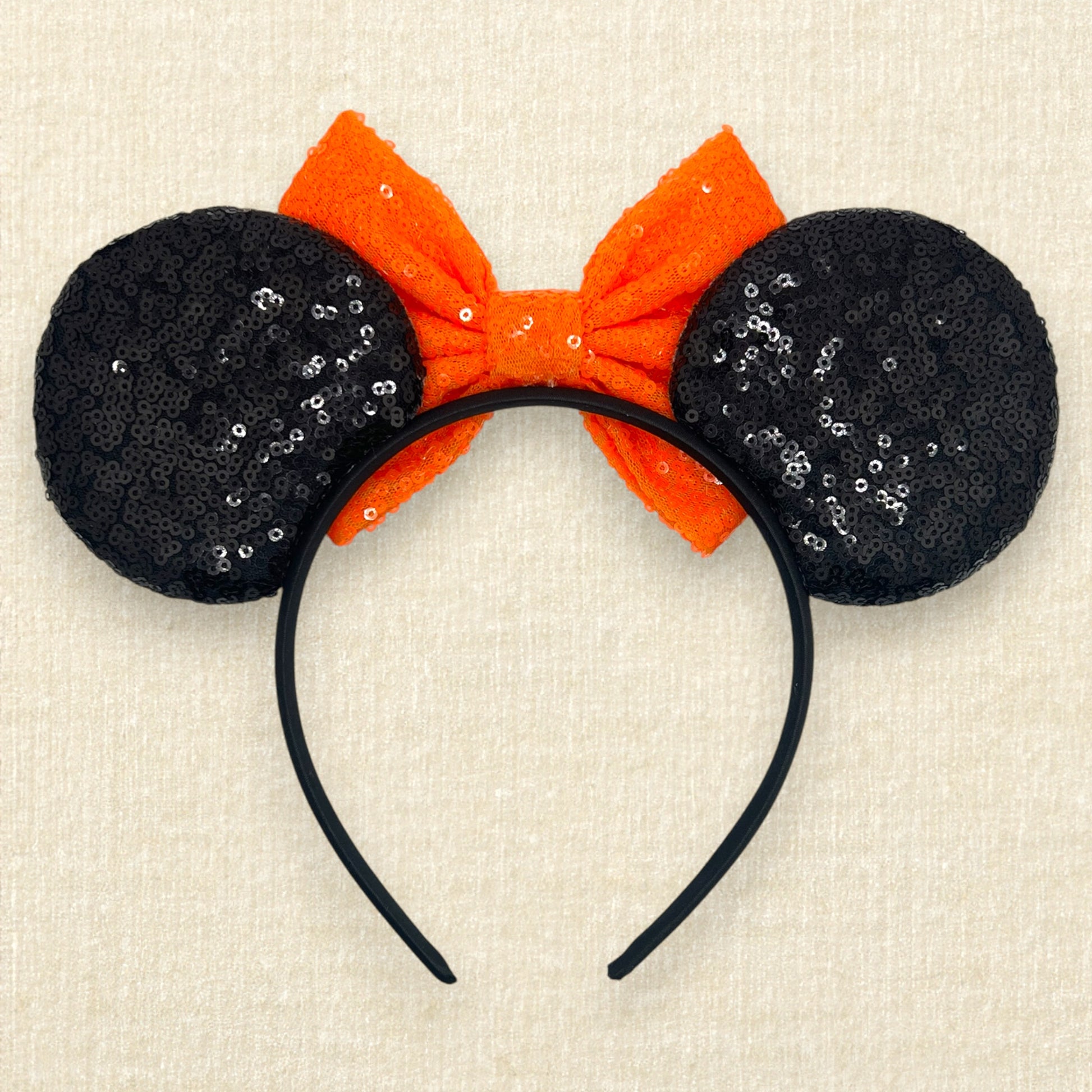 Black sequin Halloween-themed mouse ears with candy corn pieces, rhinestones, and orange sequin bow (back view)