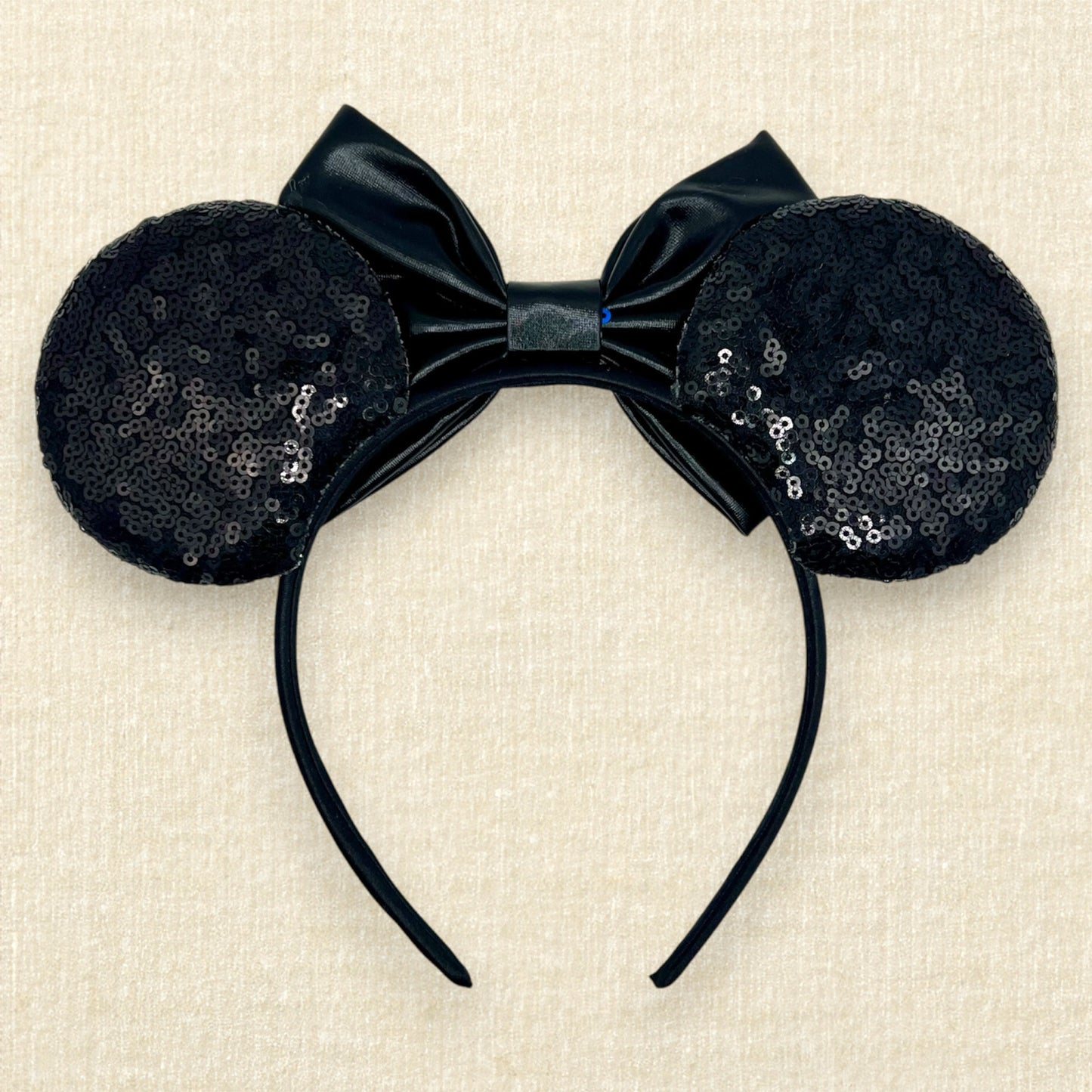 Black sequin mouse ears headband with metallic black bow, glitter details, and rhinestones (back view)