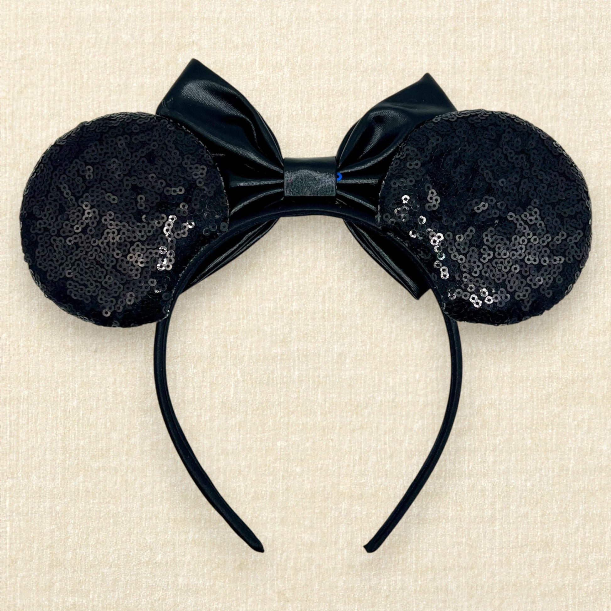 Black sequin mouse ears headband with metallic black bow, glitter details, and rhinestones (back view)