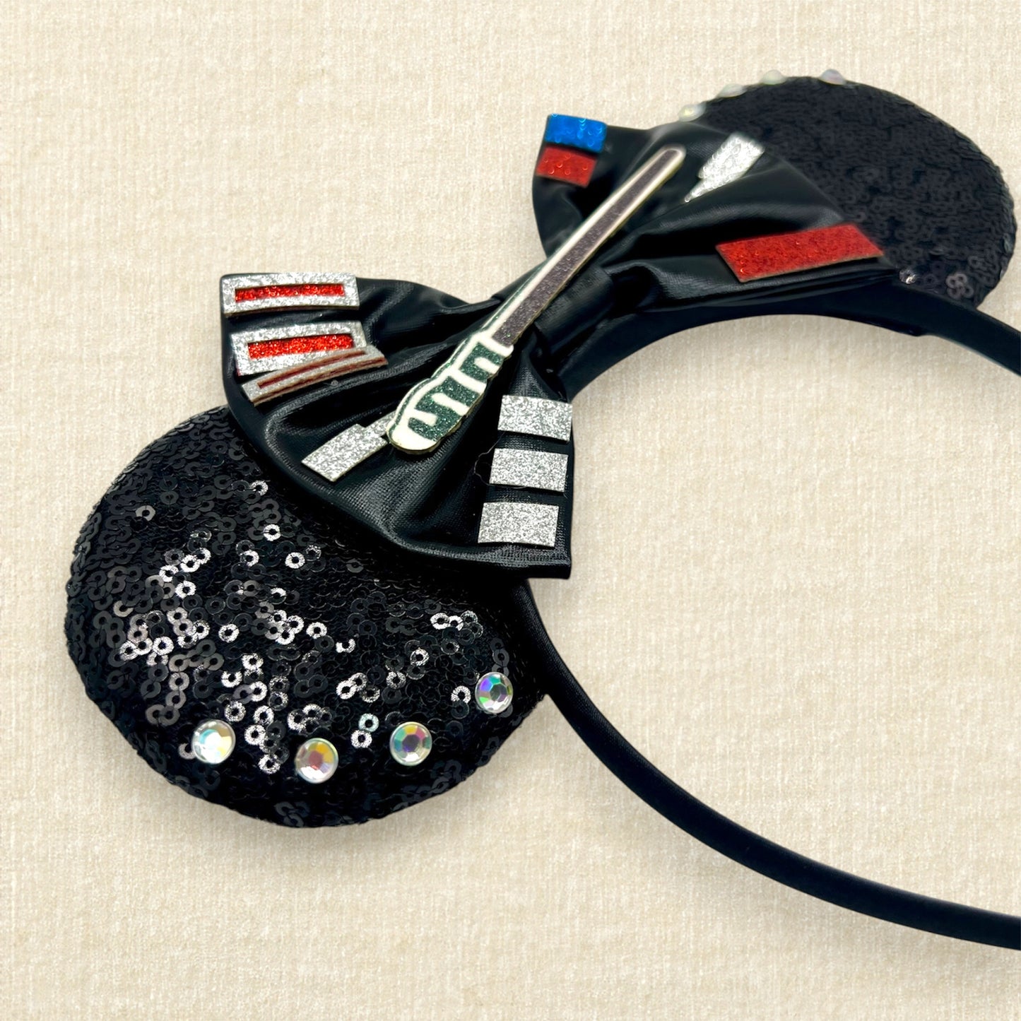 Black sequin mouse ears headband with metallic black bow, glitter details, and rhinestones
