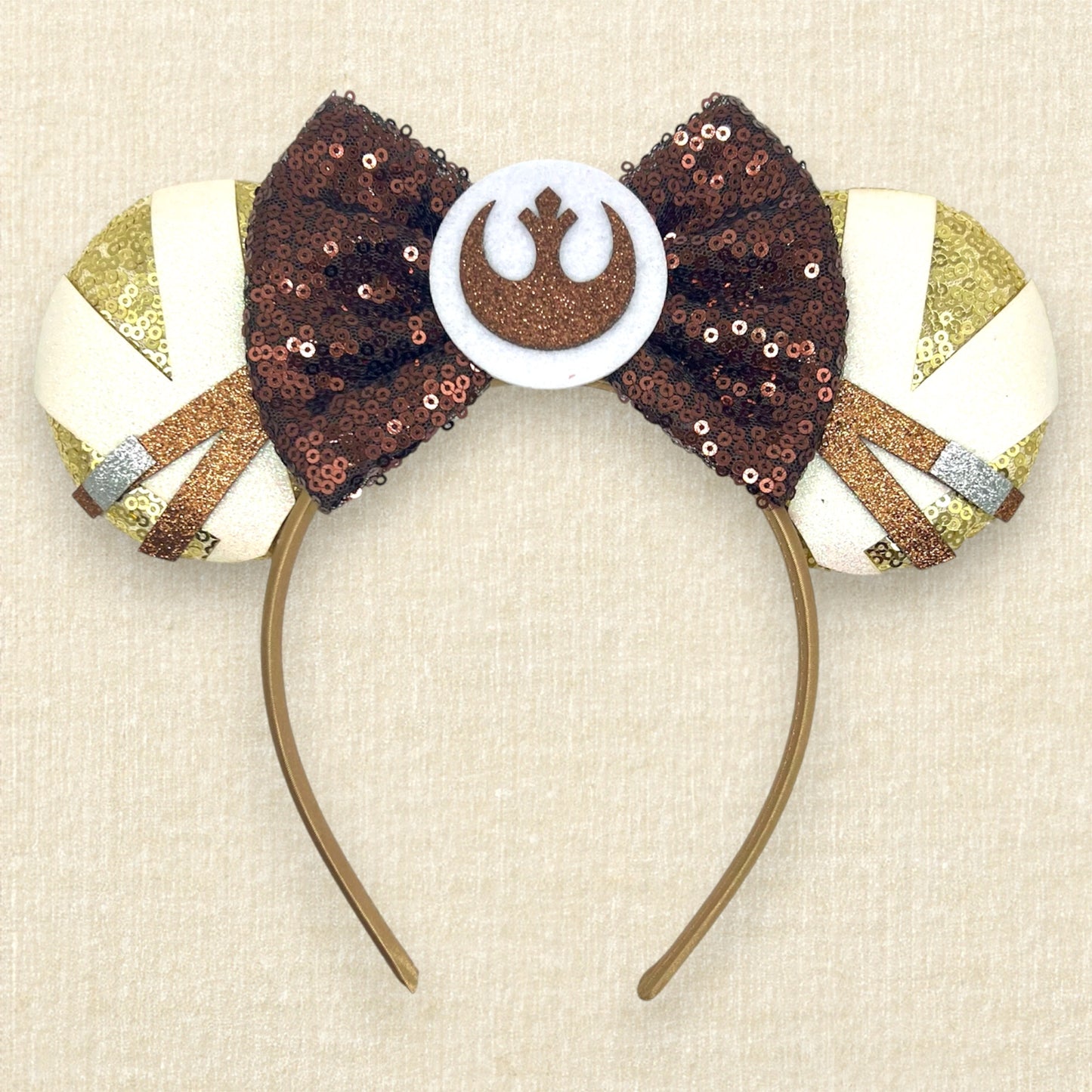 Gold sequin mouse ears with brown and white glitter details, brown sequin bow, and brown glitter emblem