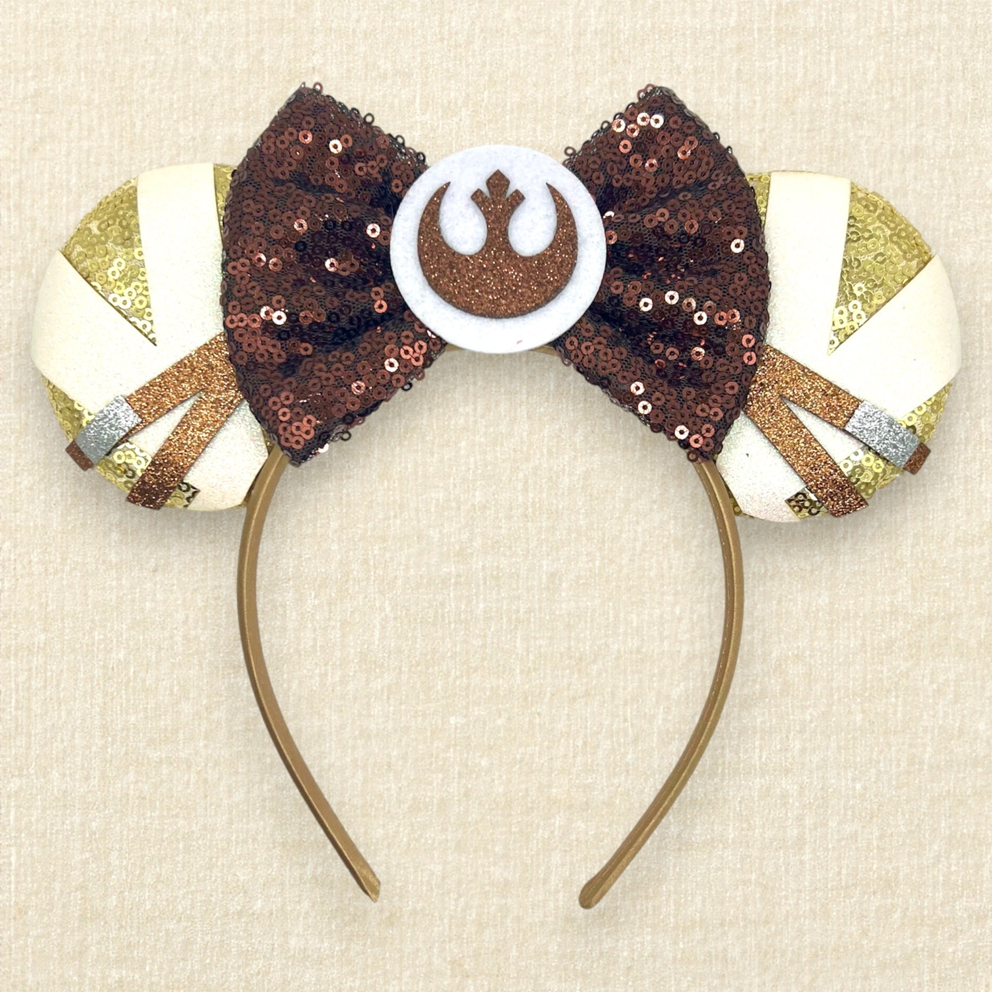 Gold sequin mouse ears with brown and white glitter details, brown sequin bow, and brown glitter emblem