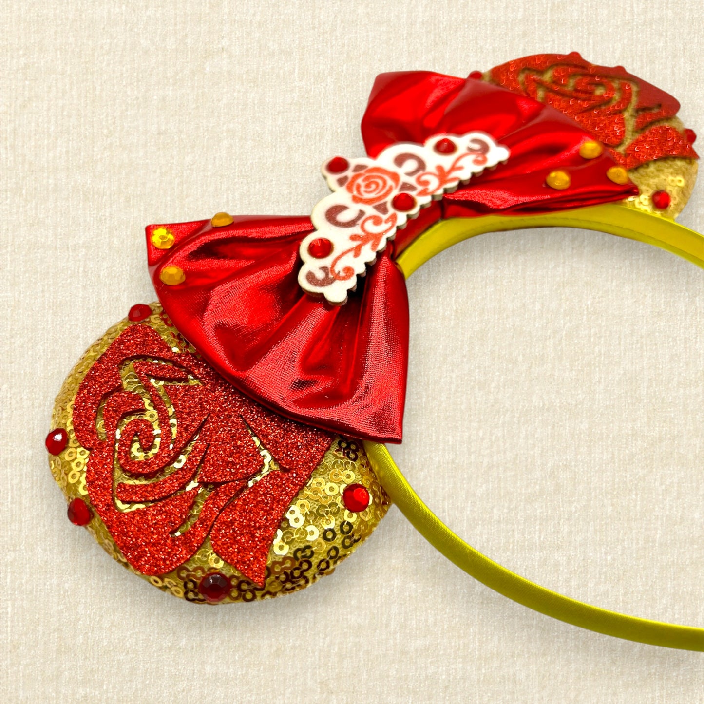 Gold mouse ears with red glitter roses, metallic red bow, glitter rose tiara, and rhinestones