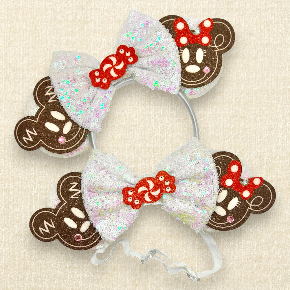 Matching holiday-themed mouse ears headbands with iridescent white sequin ears, a matching bow, brown glitter gingerbread mouse cookies, and a red and white peppermint candy centerpiece; one with a standard headband and the other with an elastic headband
