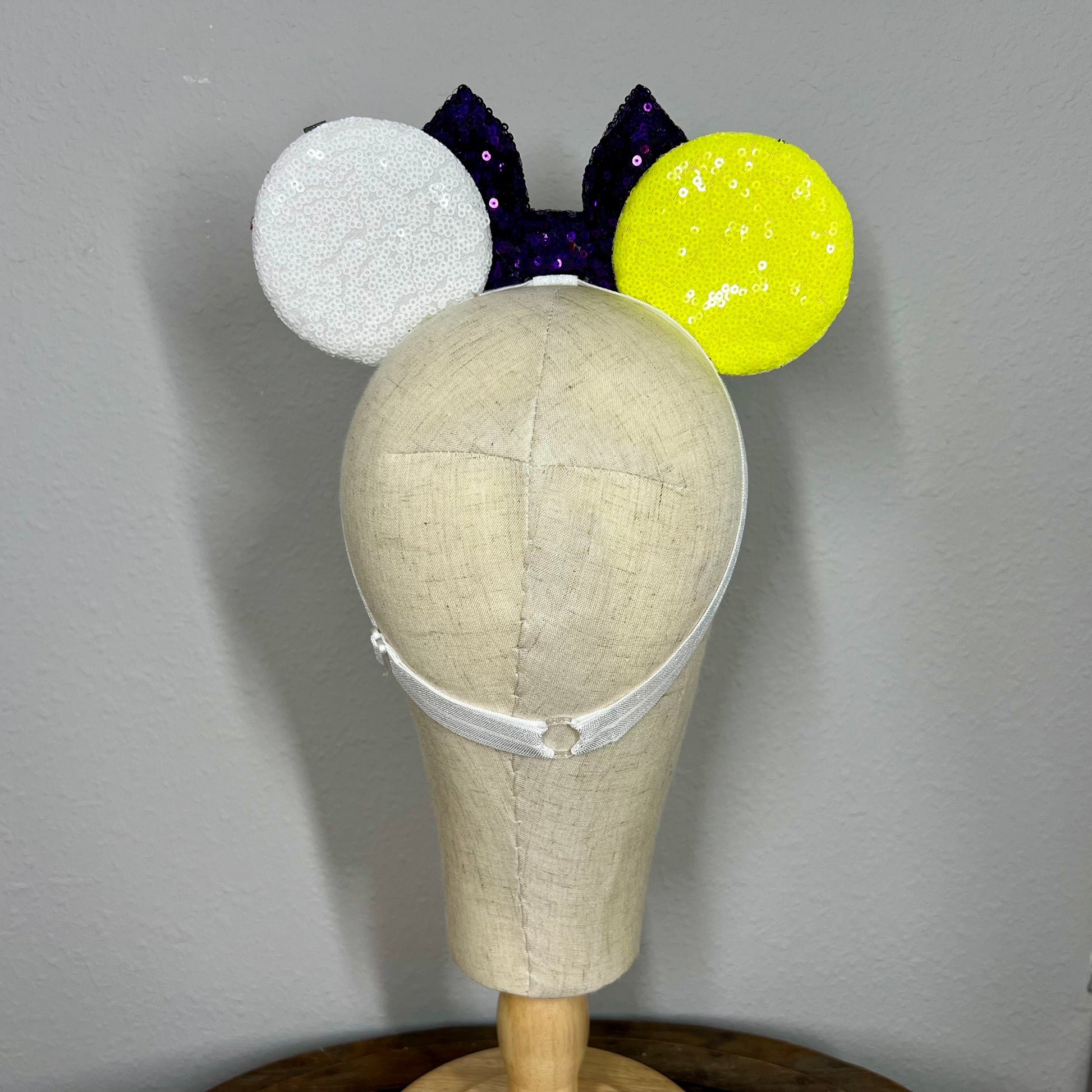 Colorful mouse ears headband with bow on a mannequin head