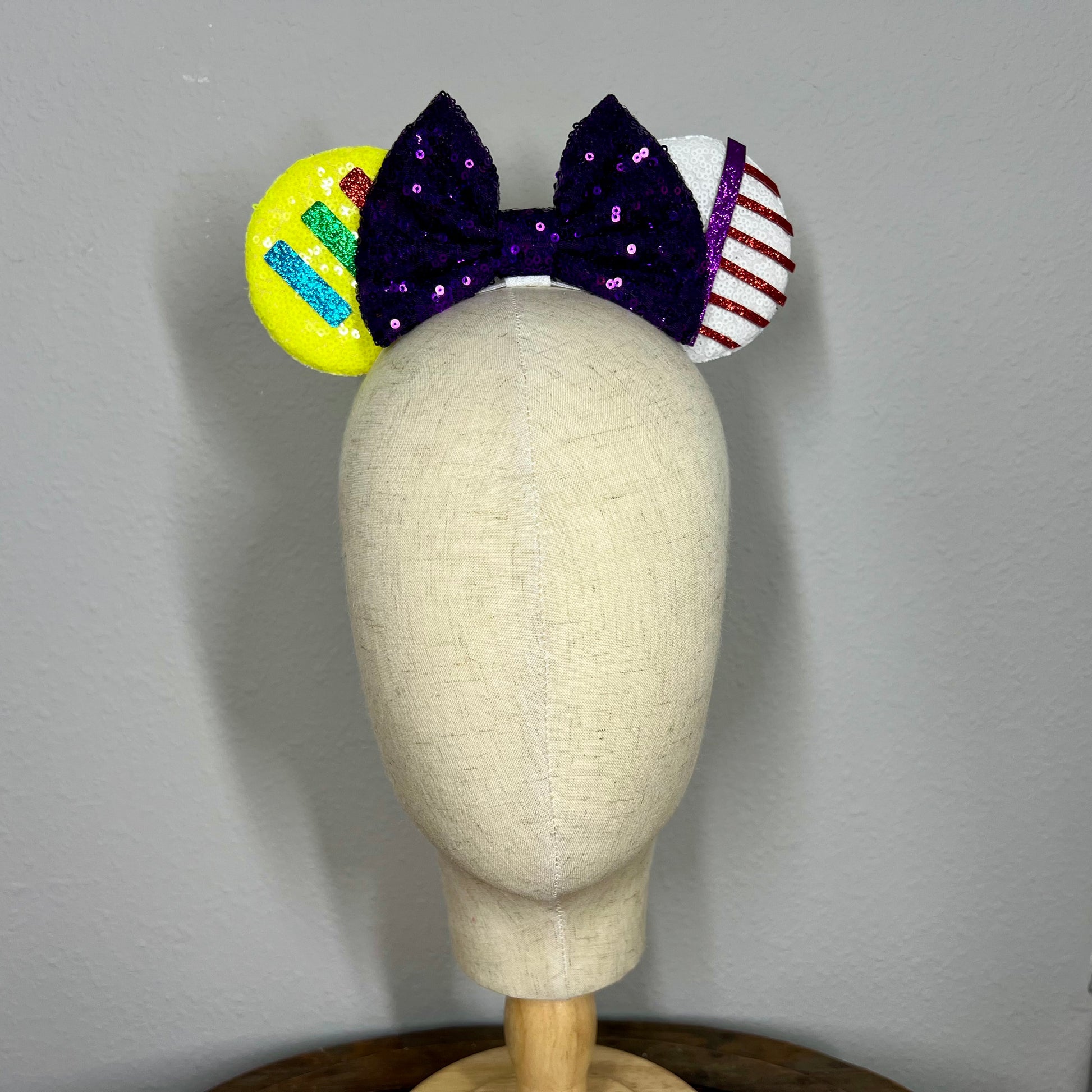 Colorful elastic mouse ears headband with bow on a mannequin head