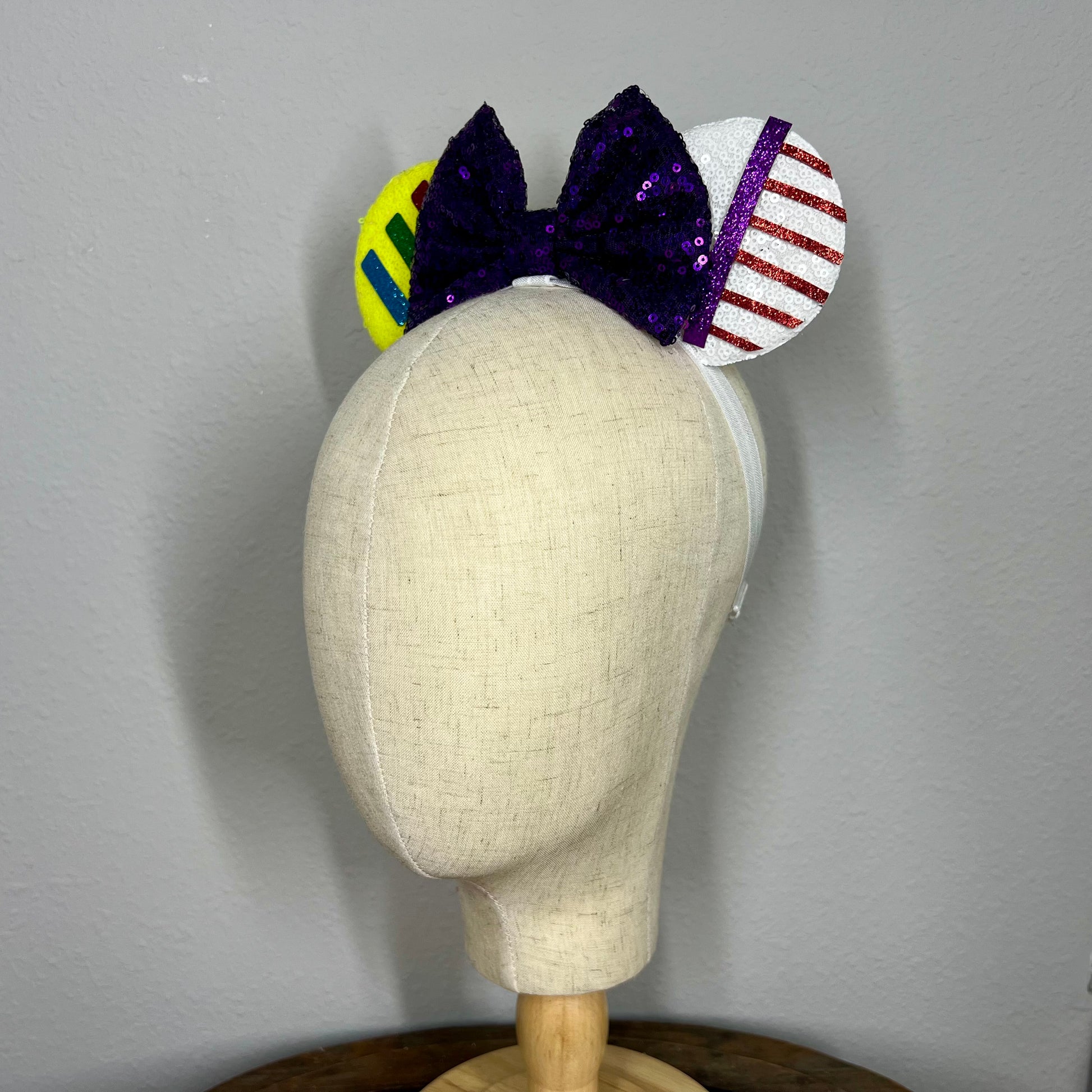 Colorful elastic mouse ears headband with bow on a mannequin head