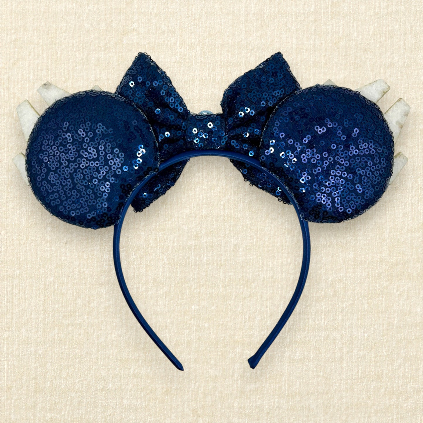 Navy blue sequin mouse ears with glitter space ships, navy blue bow, and rhinestones (back view)