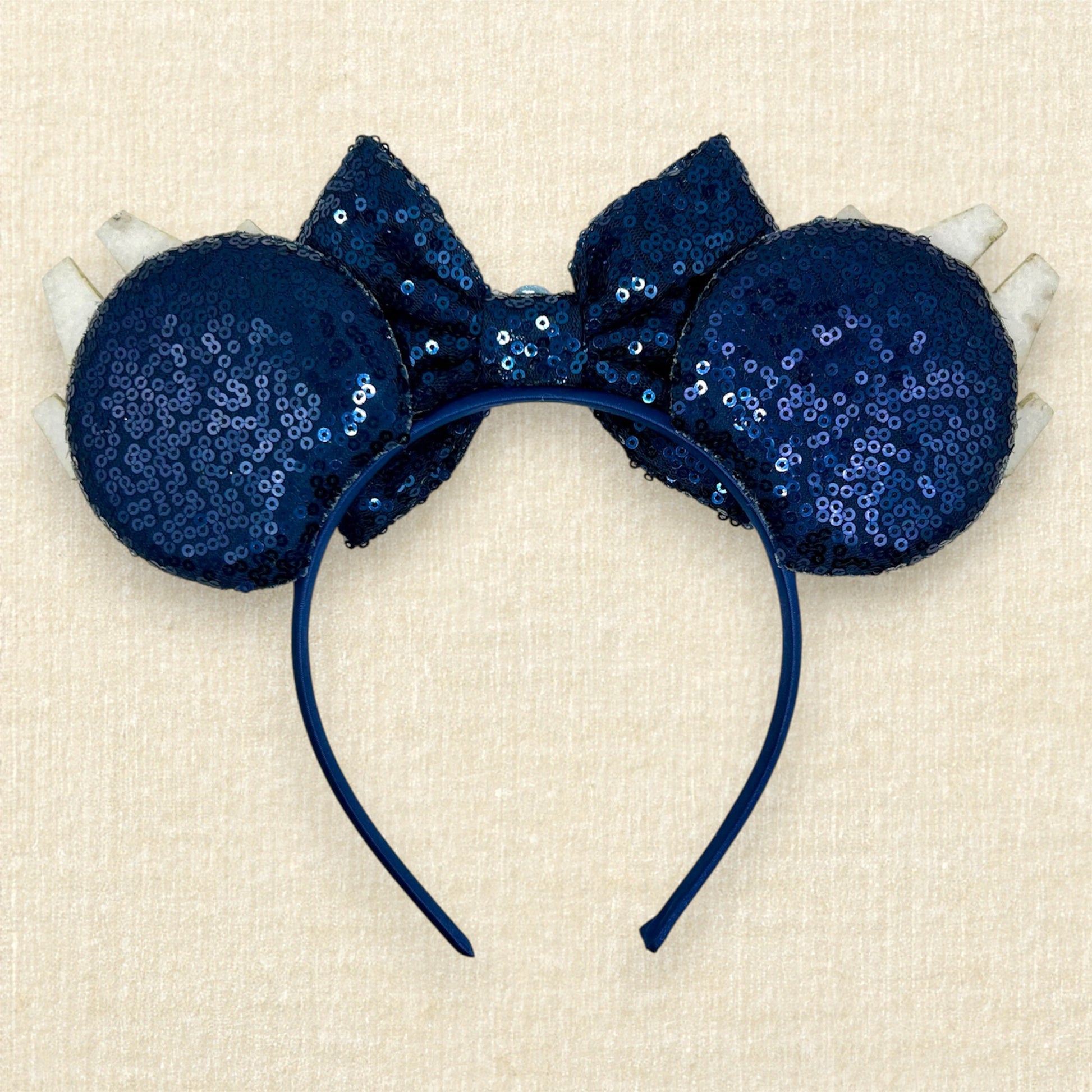 Navy blue sequin mouse ears with glitter space ships, navy blue bow, and rhinestones (back view)