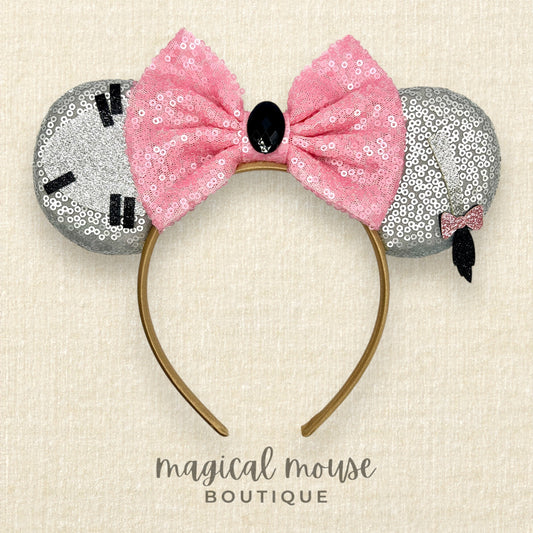 Mouse ears headband with pink bow and silver gray ears on a beige background, branded 'magical mouse boutique'.