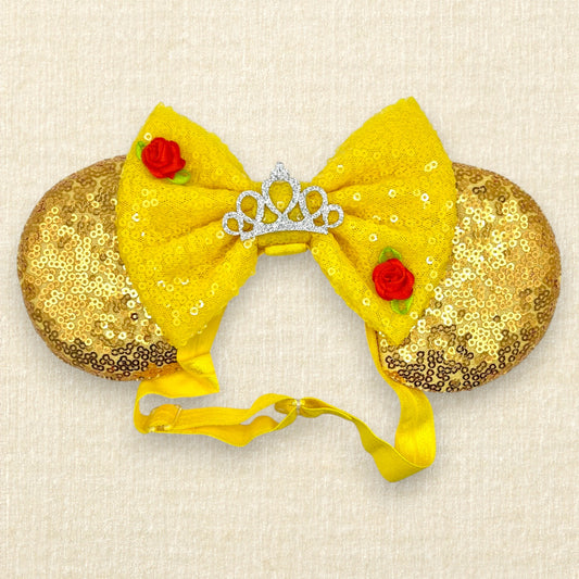 Gold sequin mouse ears with a yellow bow, silver tiara, and red roses on an elastic headband
