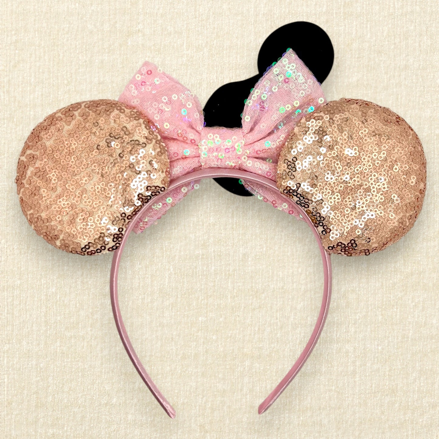 Rose gold sequin mouse ears with iridescent pink bow and glitter mouse-shaped ice cream bar (back view)
