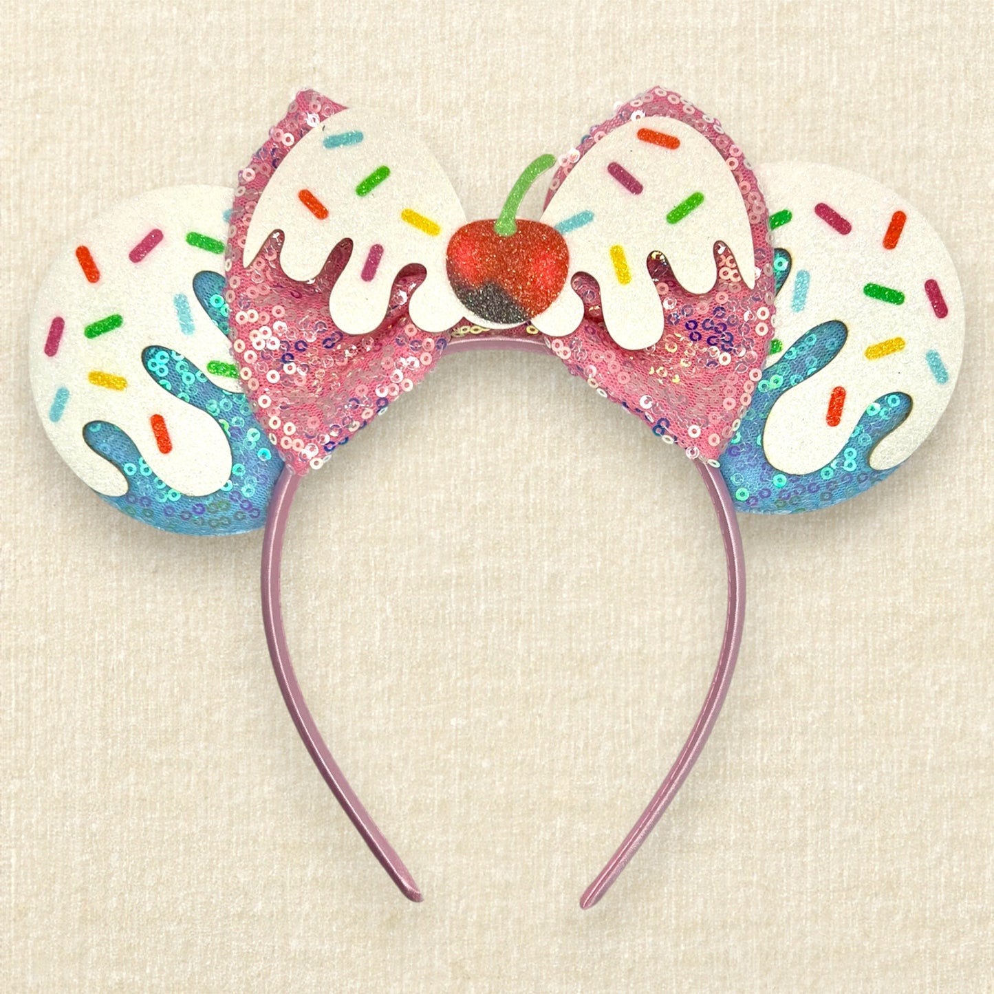 Colorful blue and pink ice cream-themed headband with sprinkles and cherry