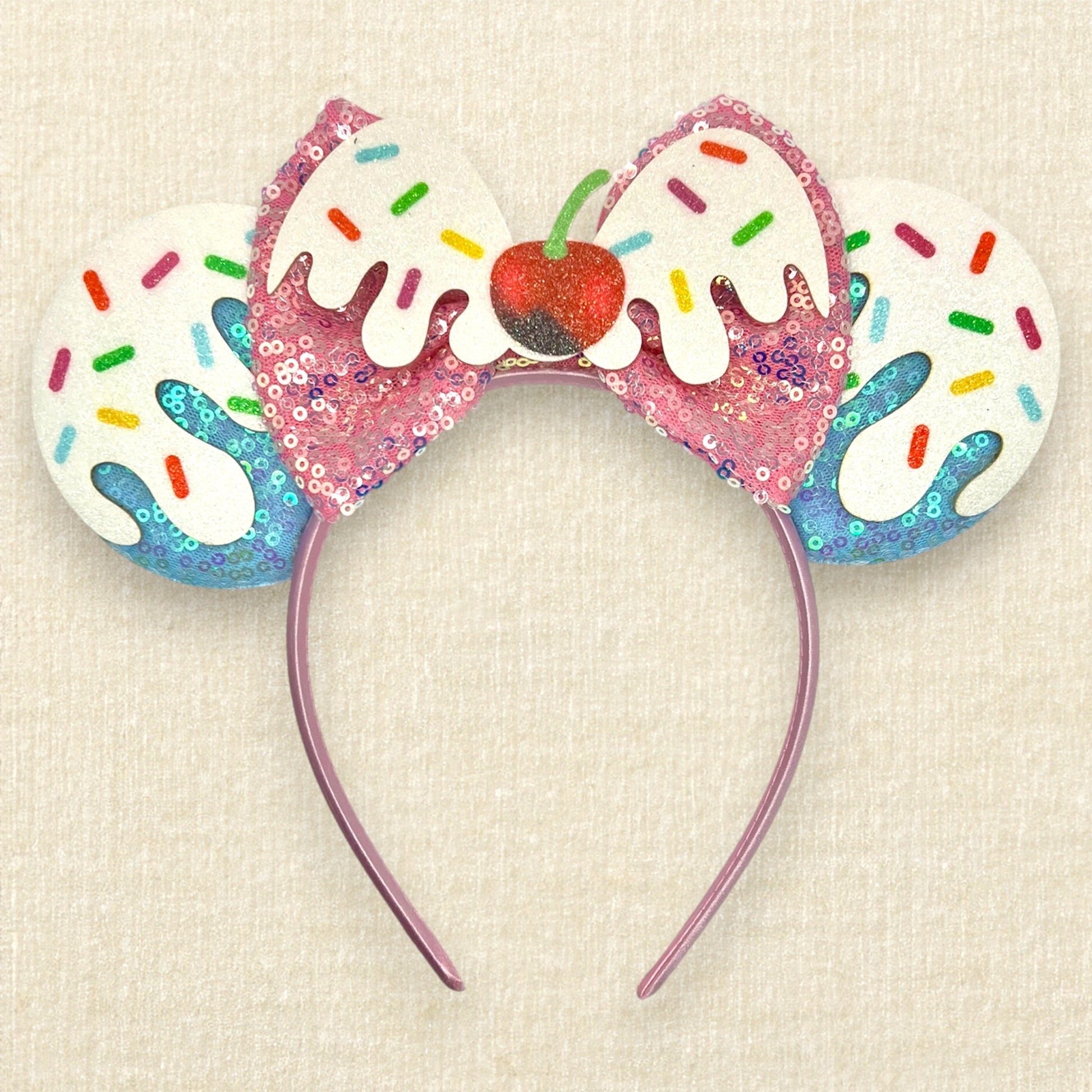 Colorful blue and pink ice cream-themed headband with sprinkles and cherry