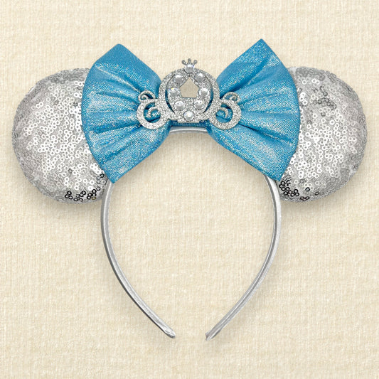 Silver sequin mouse ears with shimmery blue bow, silver glitter carriage accent, and rhinestones